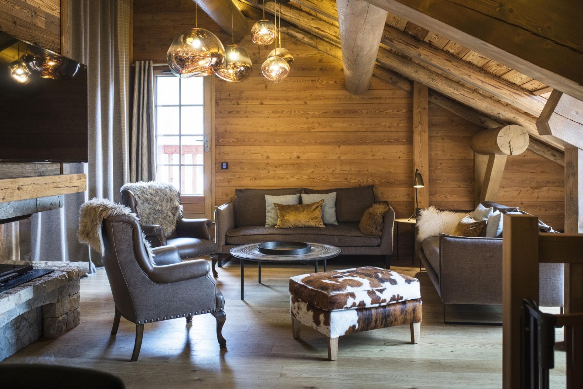 Upper floor lounge with wood fireplace and seating for six