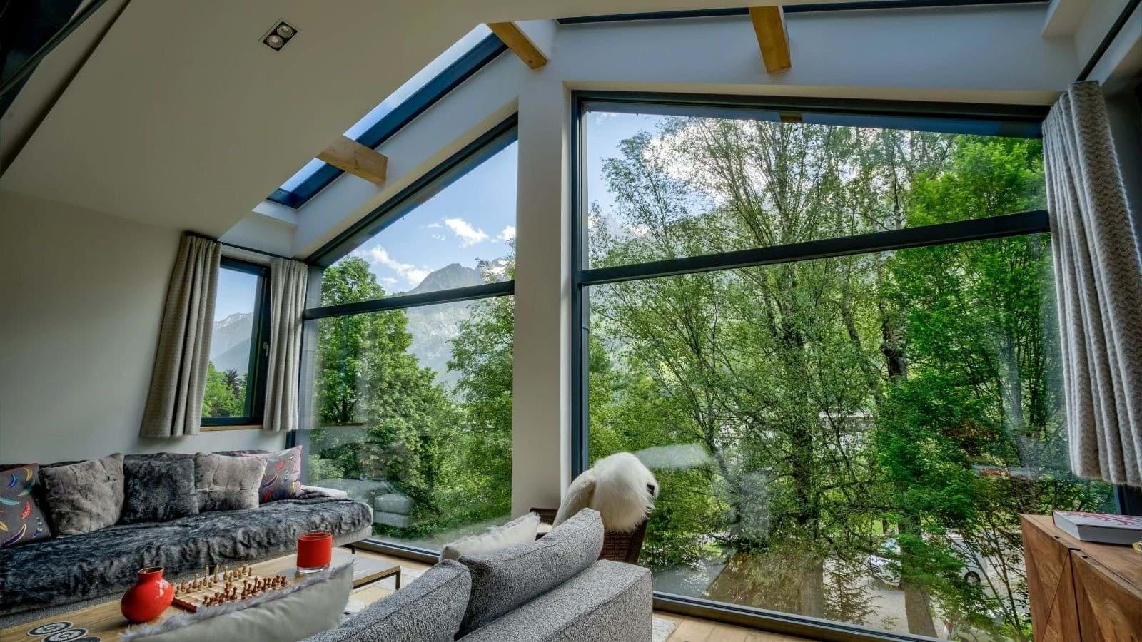 Living area with floor-to-ceiling windows and mountain views