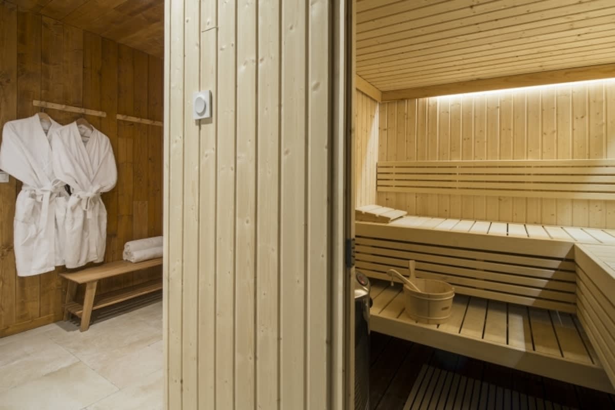 Private cedar sauna with tiered seating and changing area