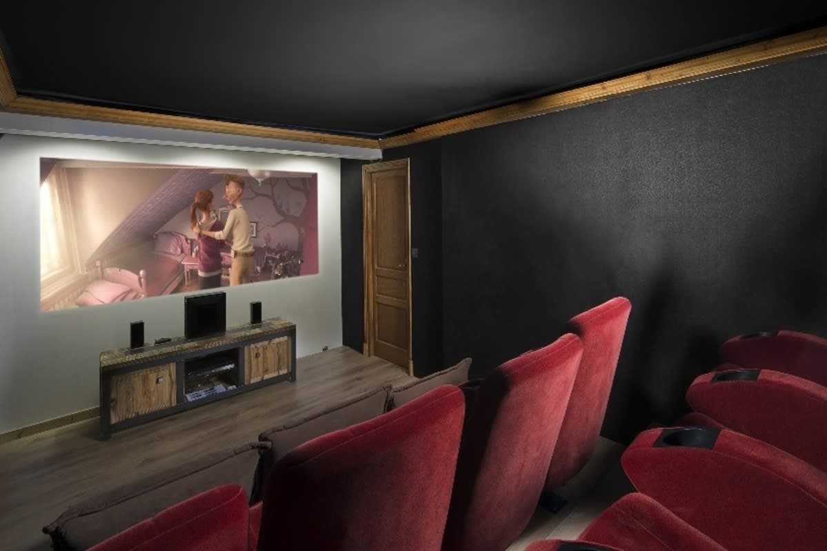 Media room with projector screen and tiered theater seating for 6