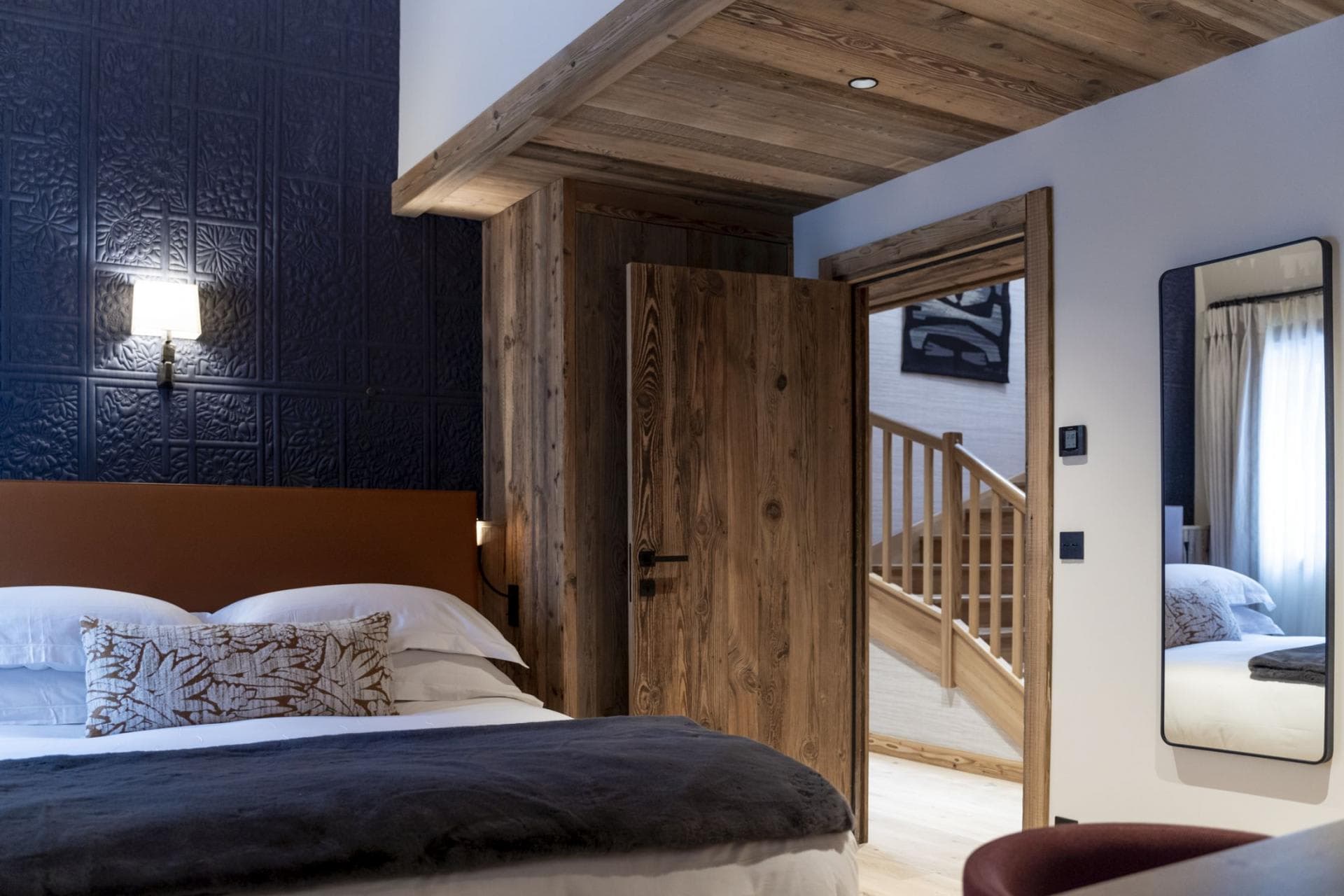 Guest bedroom with reclaim wood accents and embossed metal wall paneling