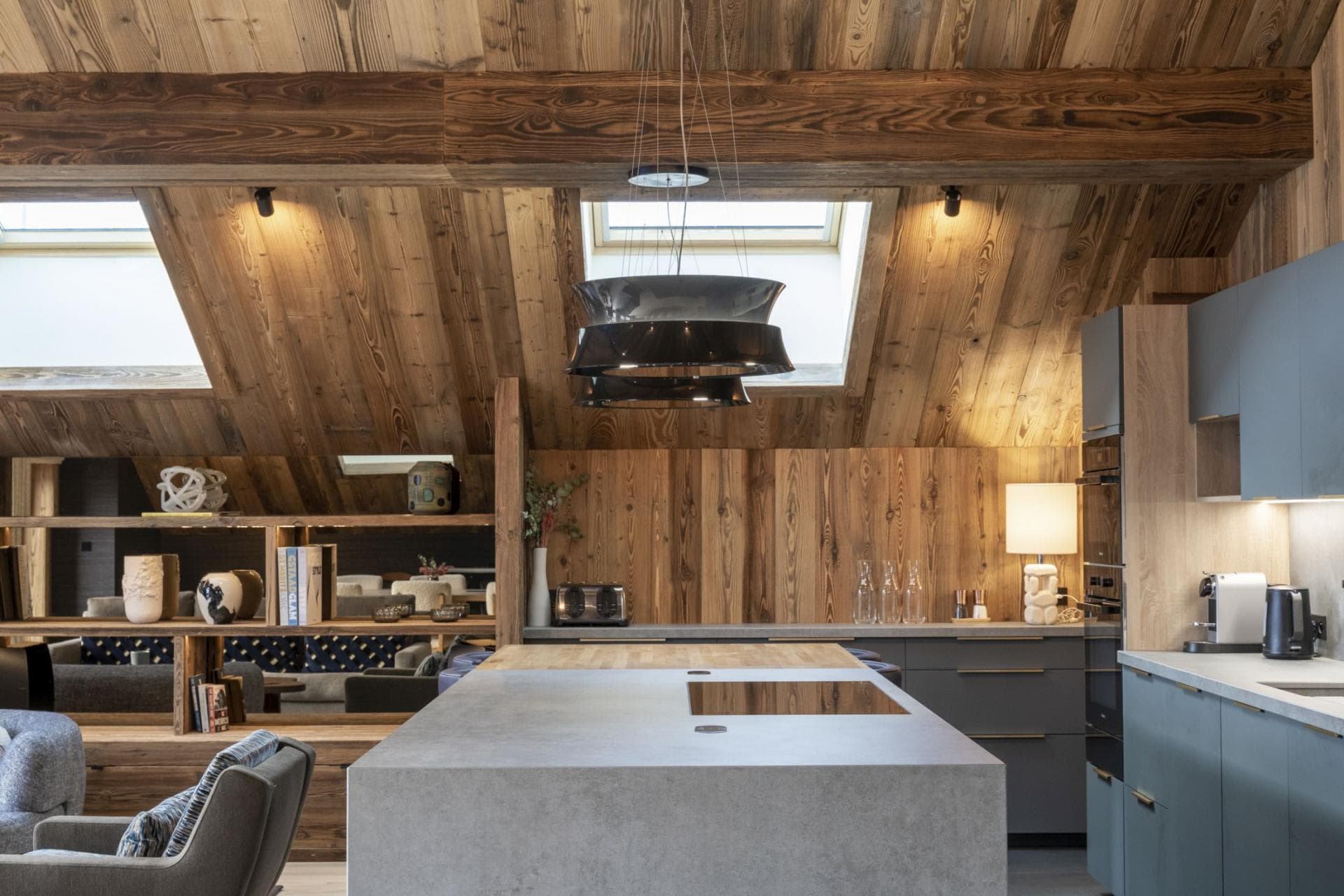 Kitchen island with integrated induction cooktop and overhead skylights