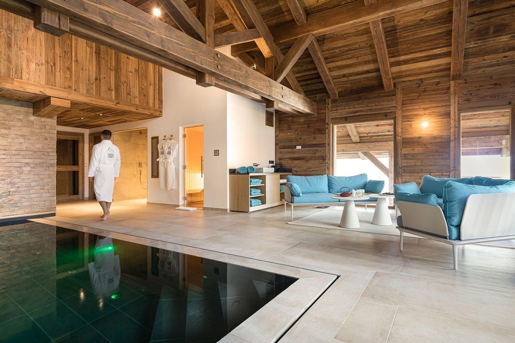 Wellness area with indoor pool, sauna, and lounge seating