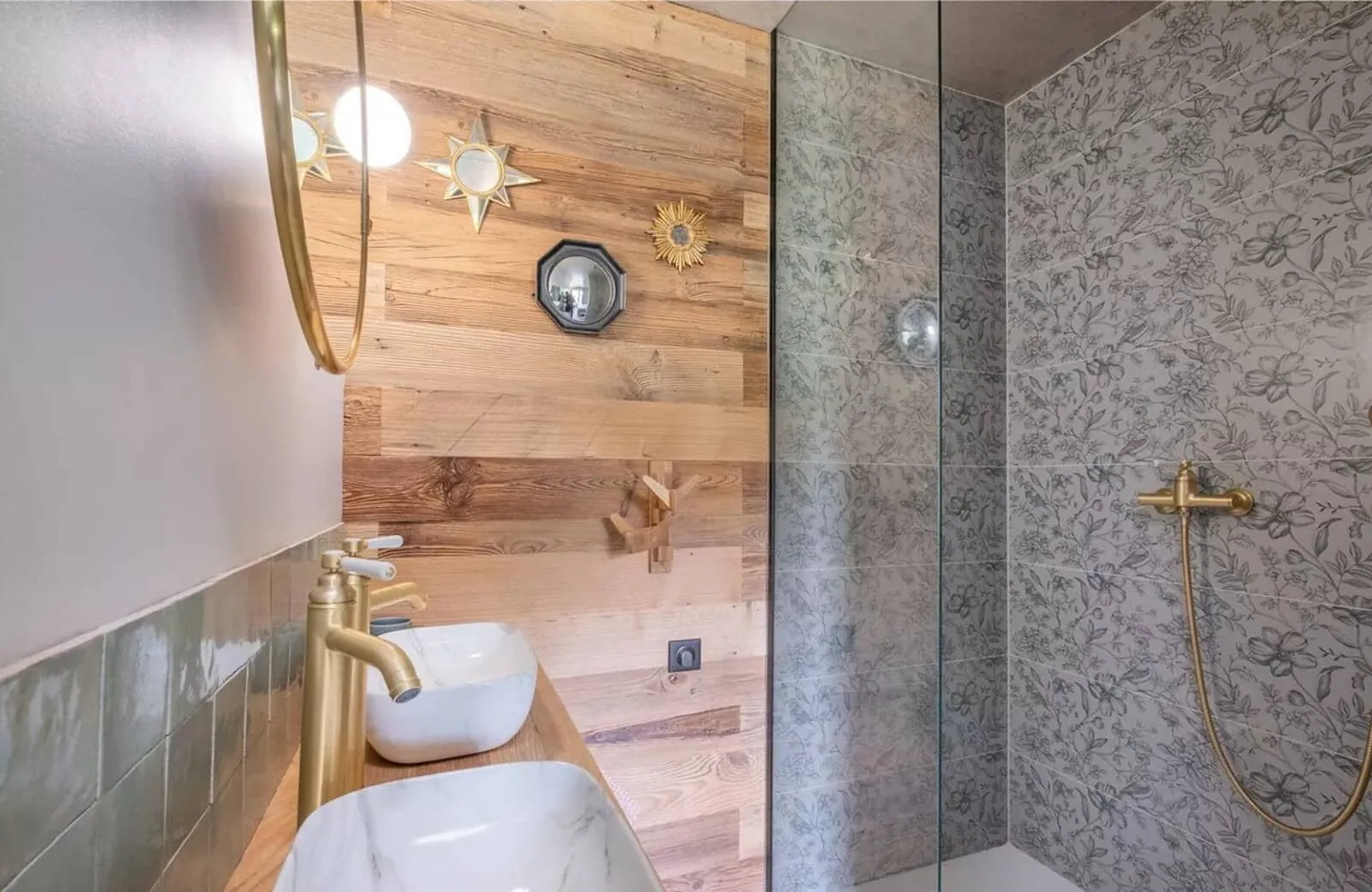 Bathroom with dual vanity and walk-in shower with patterned tile