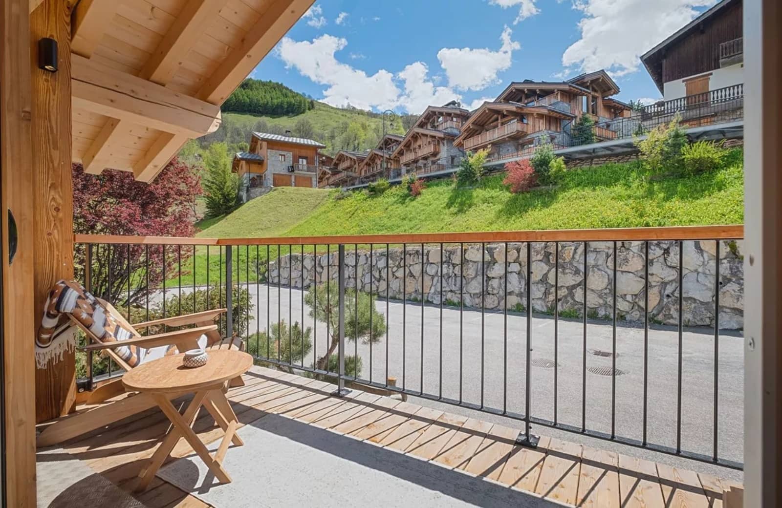 Private balcony with lounge seating and mountain chalet views