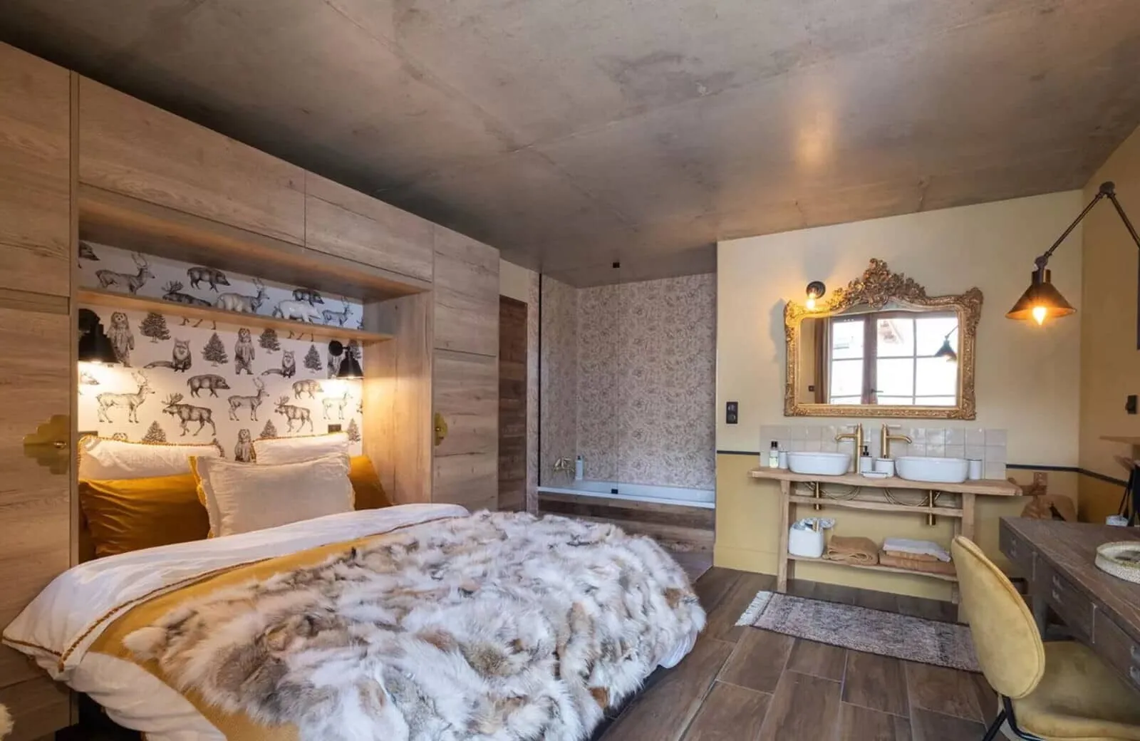 Bedroom with king bed, ensuite bathtub, and dual vanity sinks