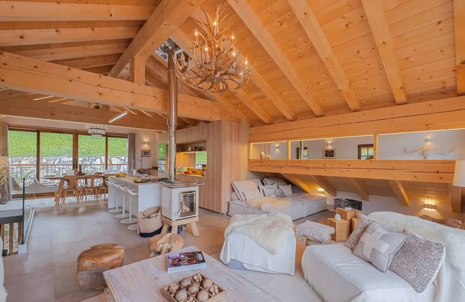 Open-plan living area with wood-burning stove and dining for 8