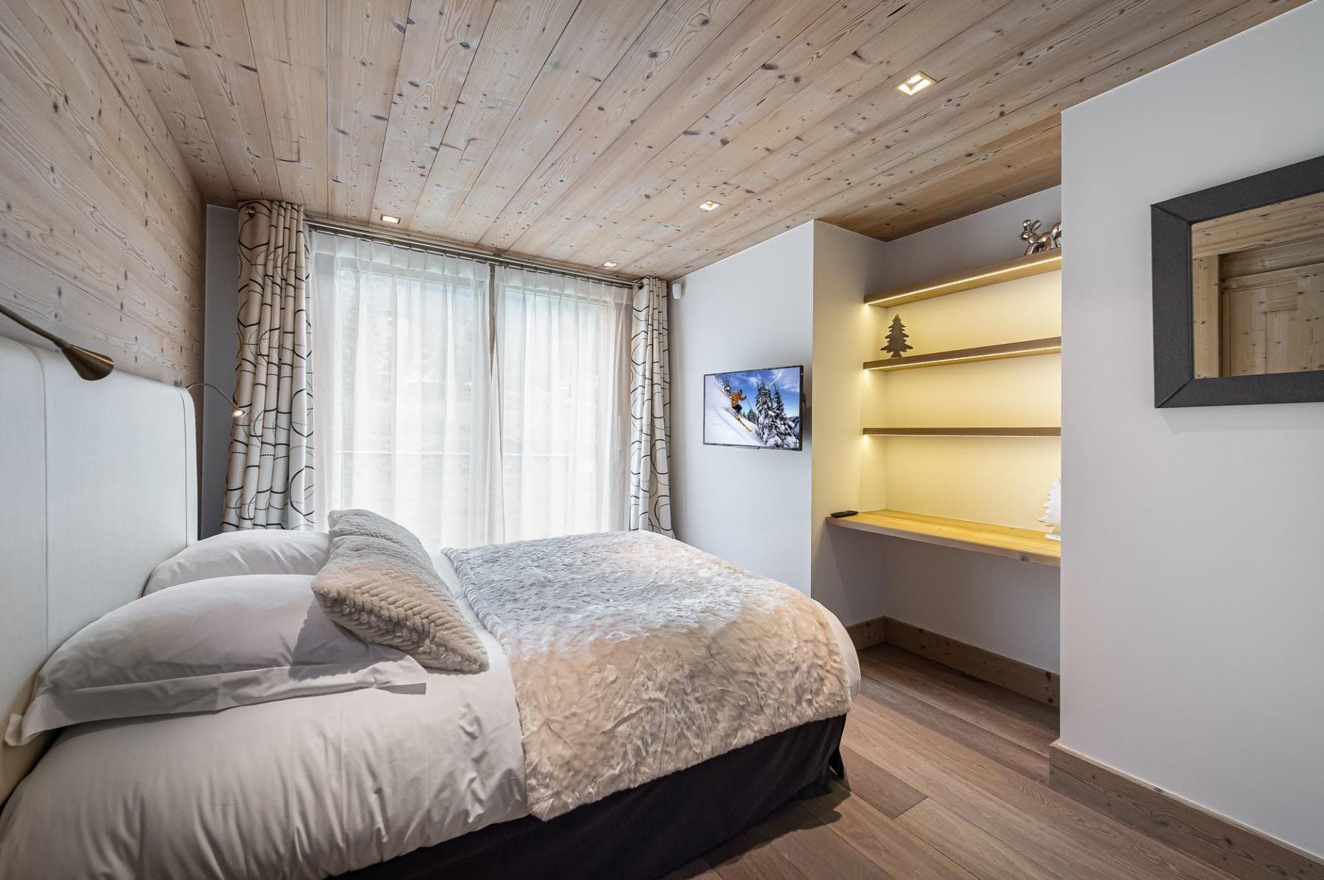 Bedroom with wood-paneled ceiling and built-in desk
