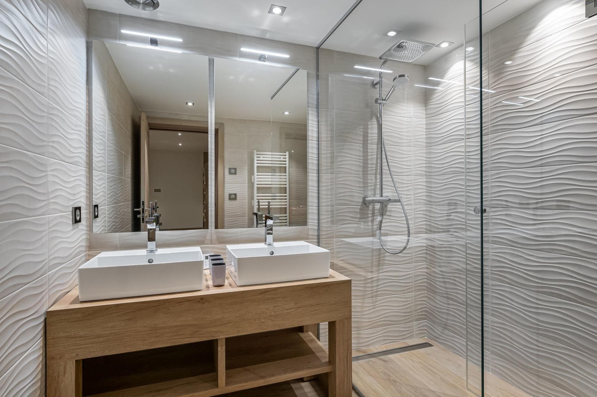 Bathroom with double vanity and walk-in shower including rain showerhead