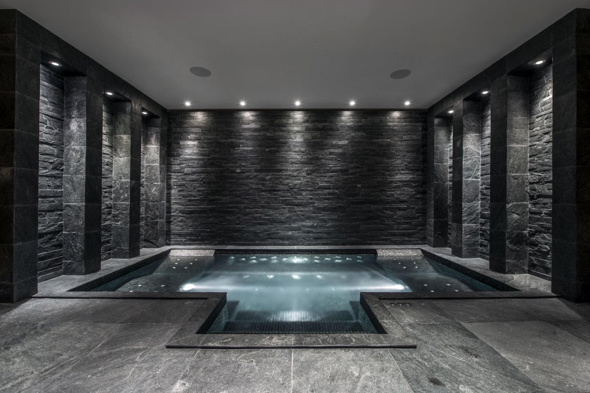 Indoor stone spa with integrated ceiling speakers