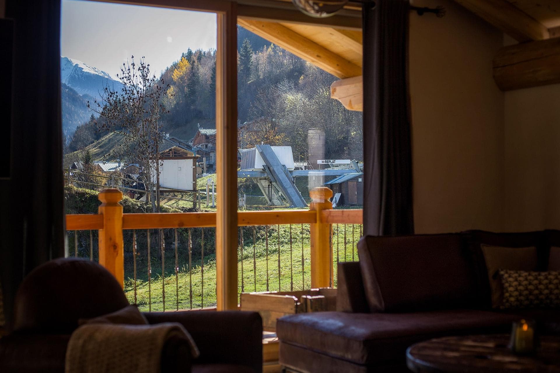 Living area with balcony access and views of the Replat ski lift