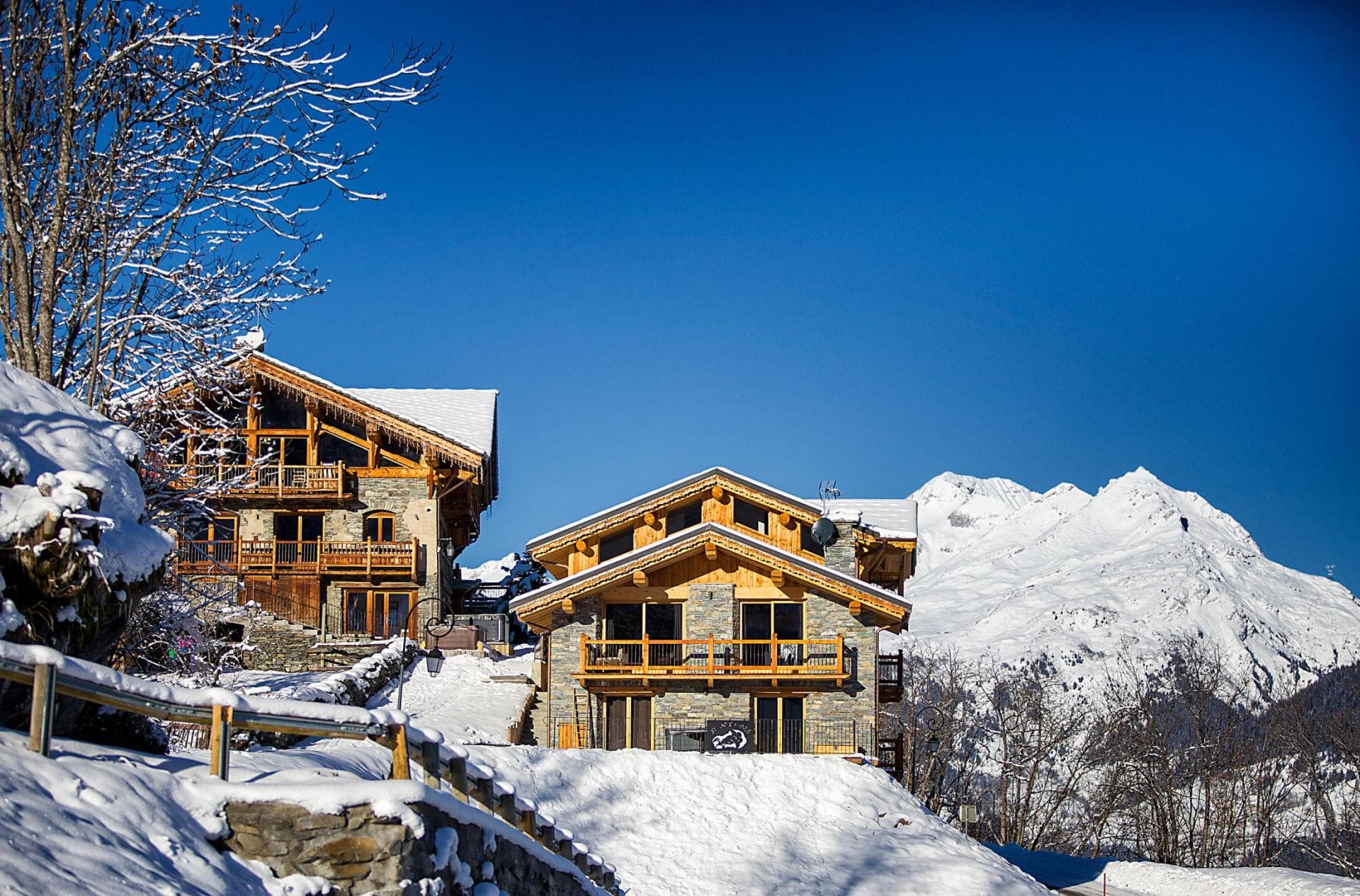 Chalet exterior with private balconies and panoramic alpine mountain views