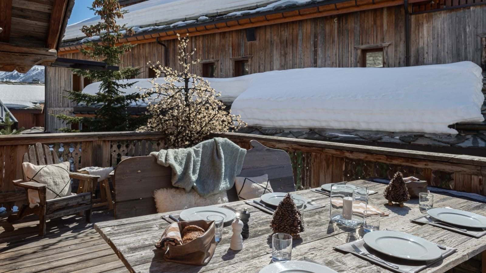 Deck dining table seats 8; alpine mountain views with snow-capped peaks