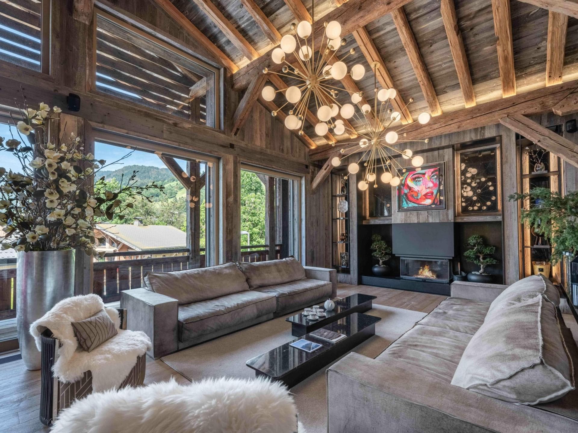 Living area with fireplace, vaulted wood ceilings, and floor-to-ceiling valley views