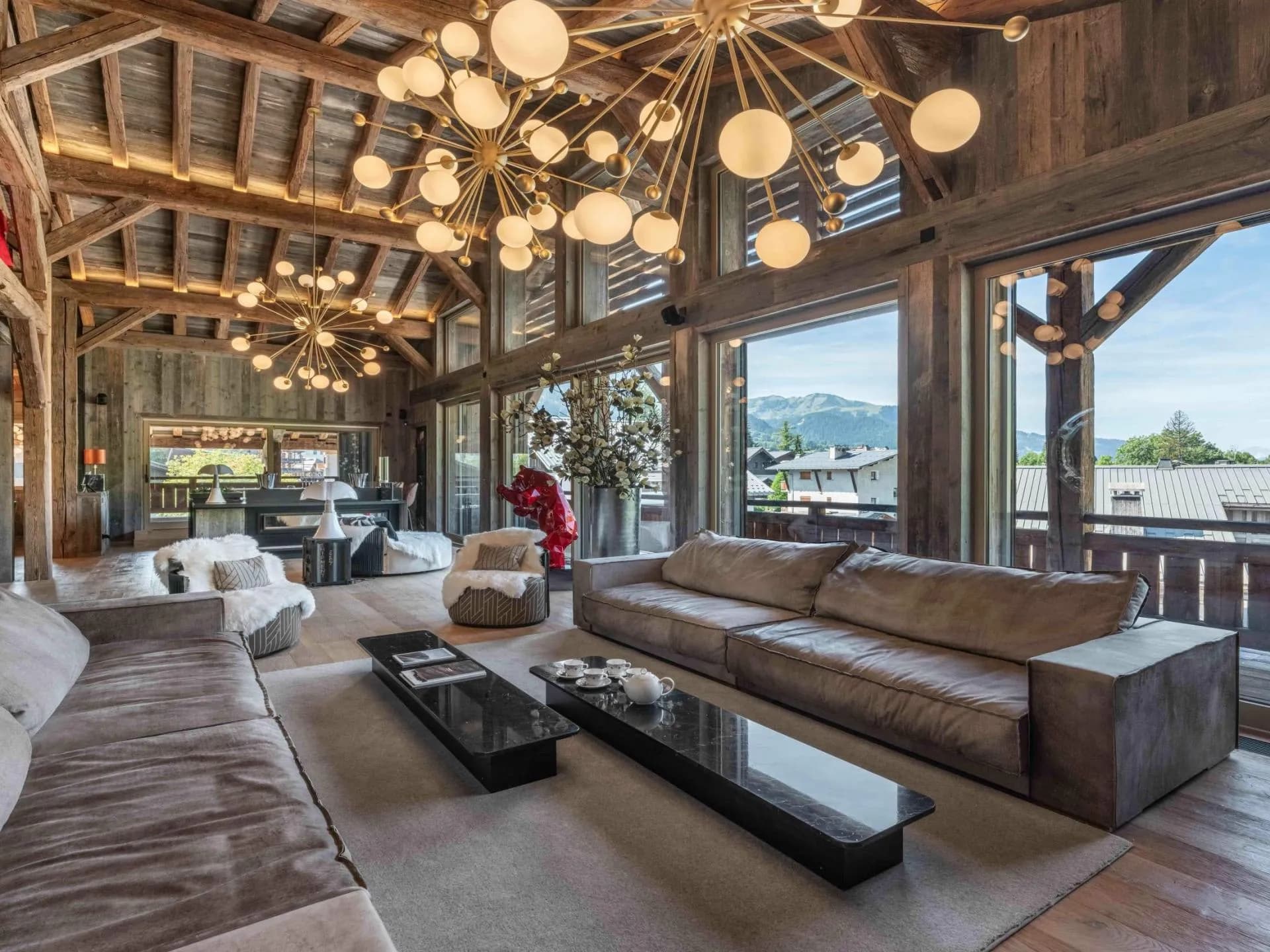 Living room with exposed beams and large windows