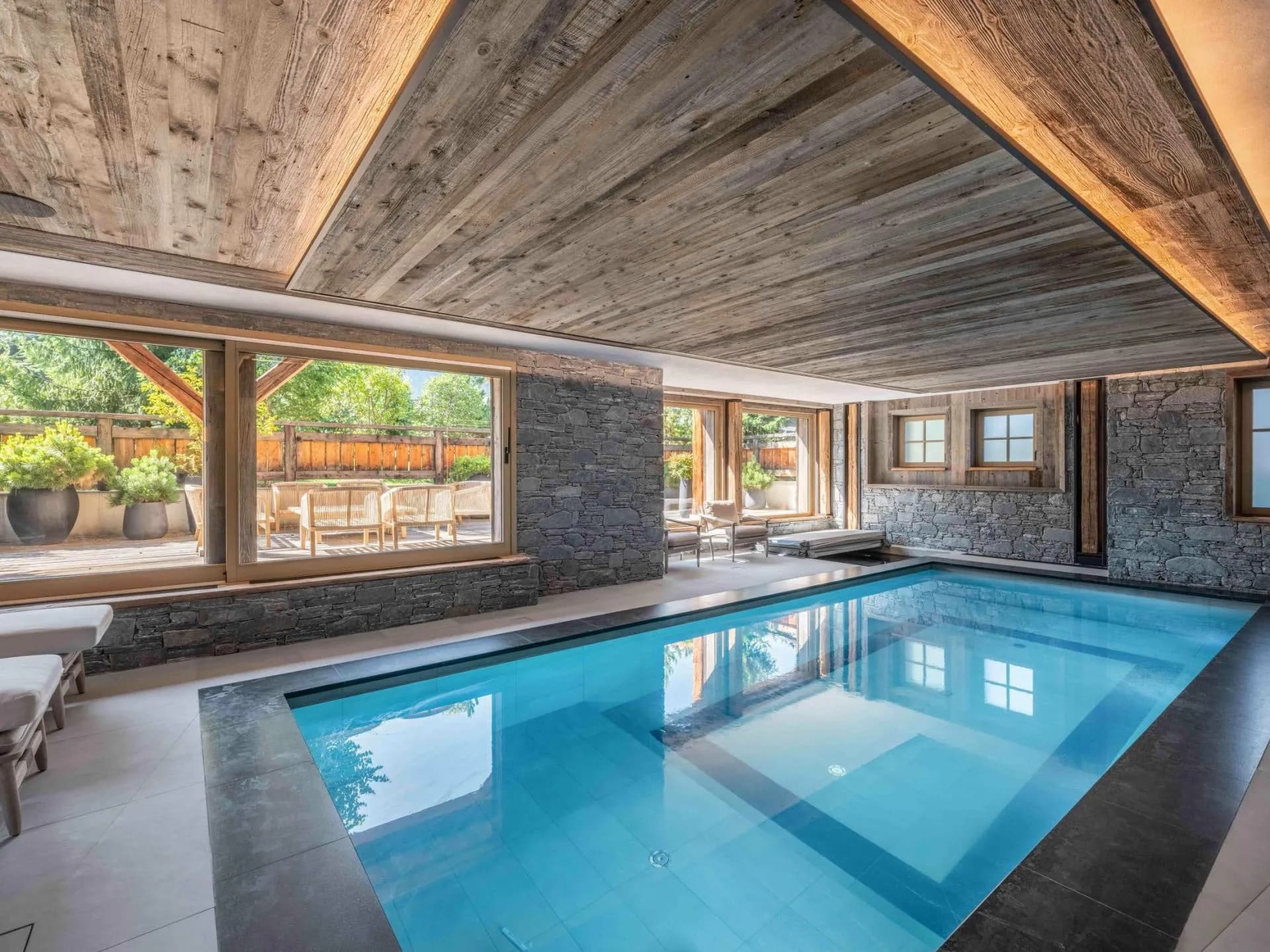 Indoor pool beside glazed doors opening to the terrace