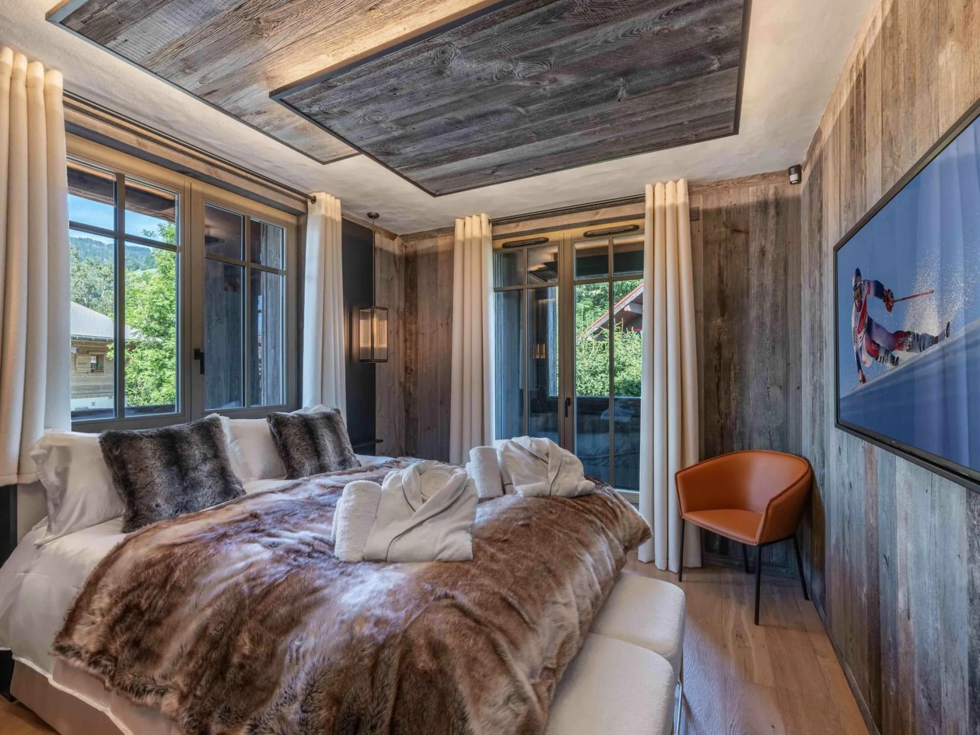 Double bedroom with timber panelling and glazed doors