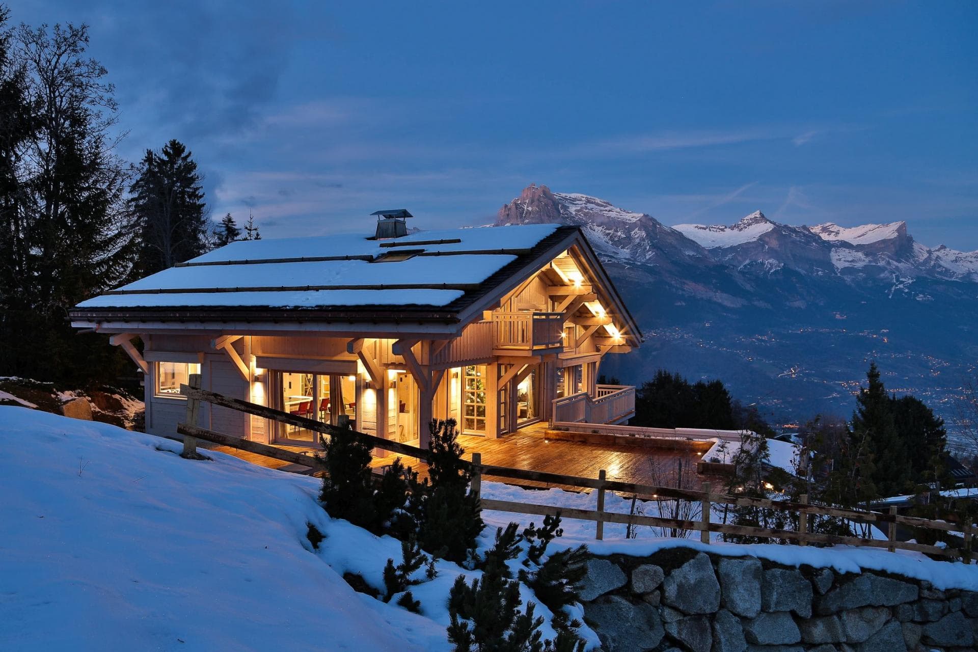 Chalet exterior with wrap-around deck and panoramic alpine views