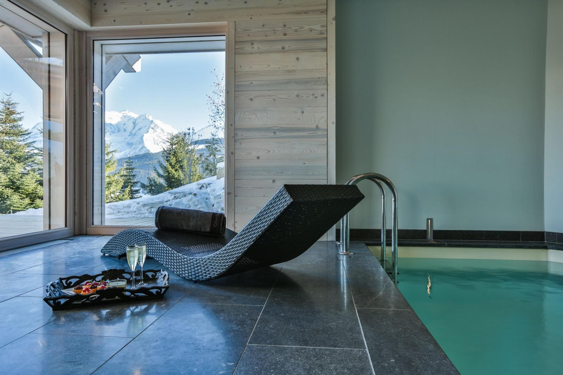 Indoor pool with floor-to-ceiling mountain views