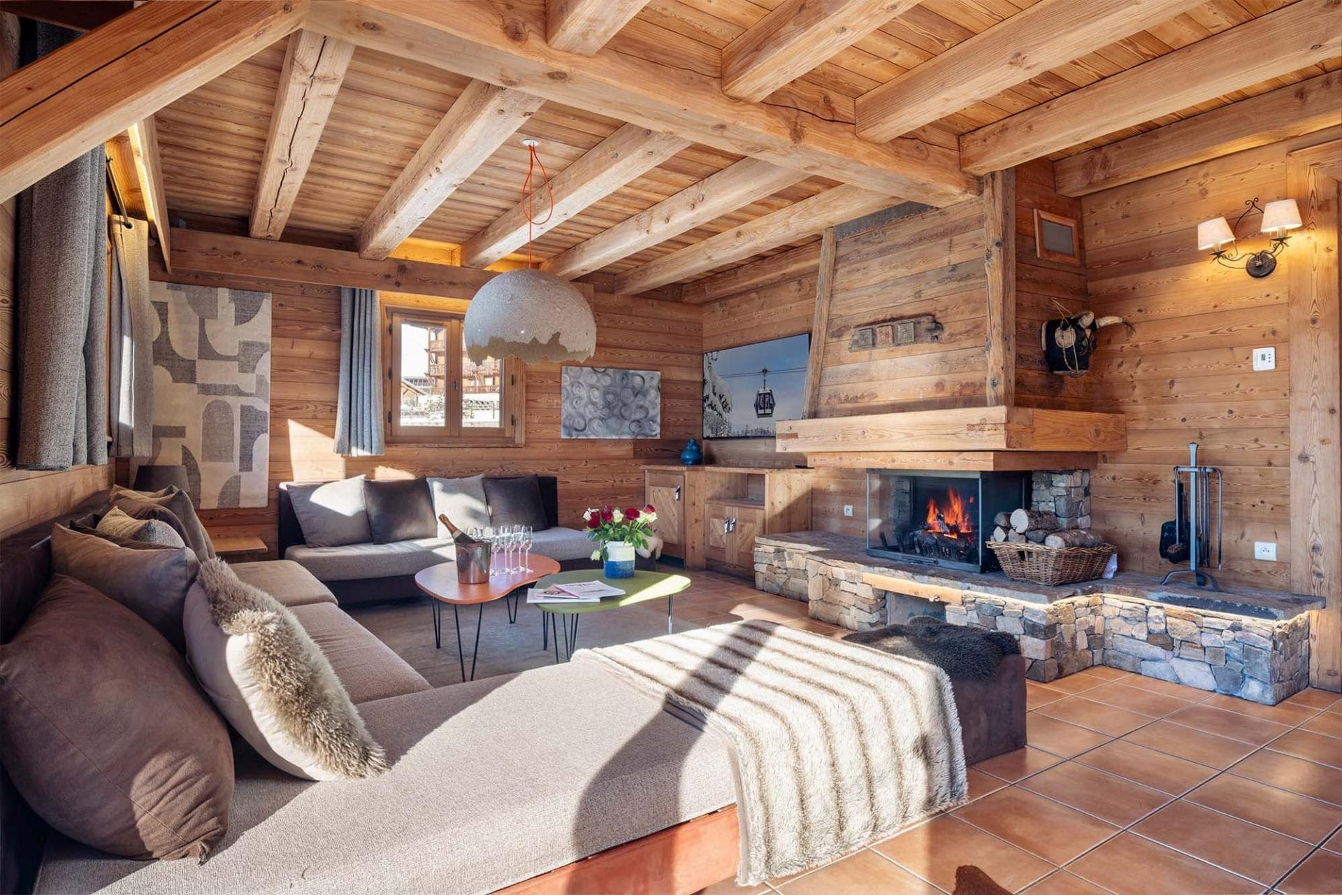 Living area with wood-burning fireplace and exposed timber beams