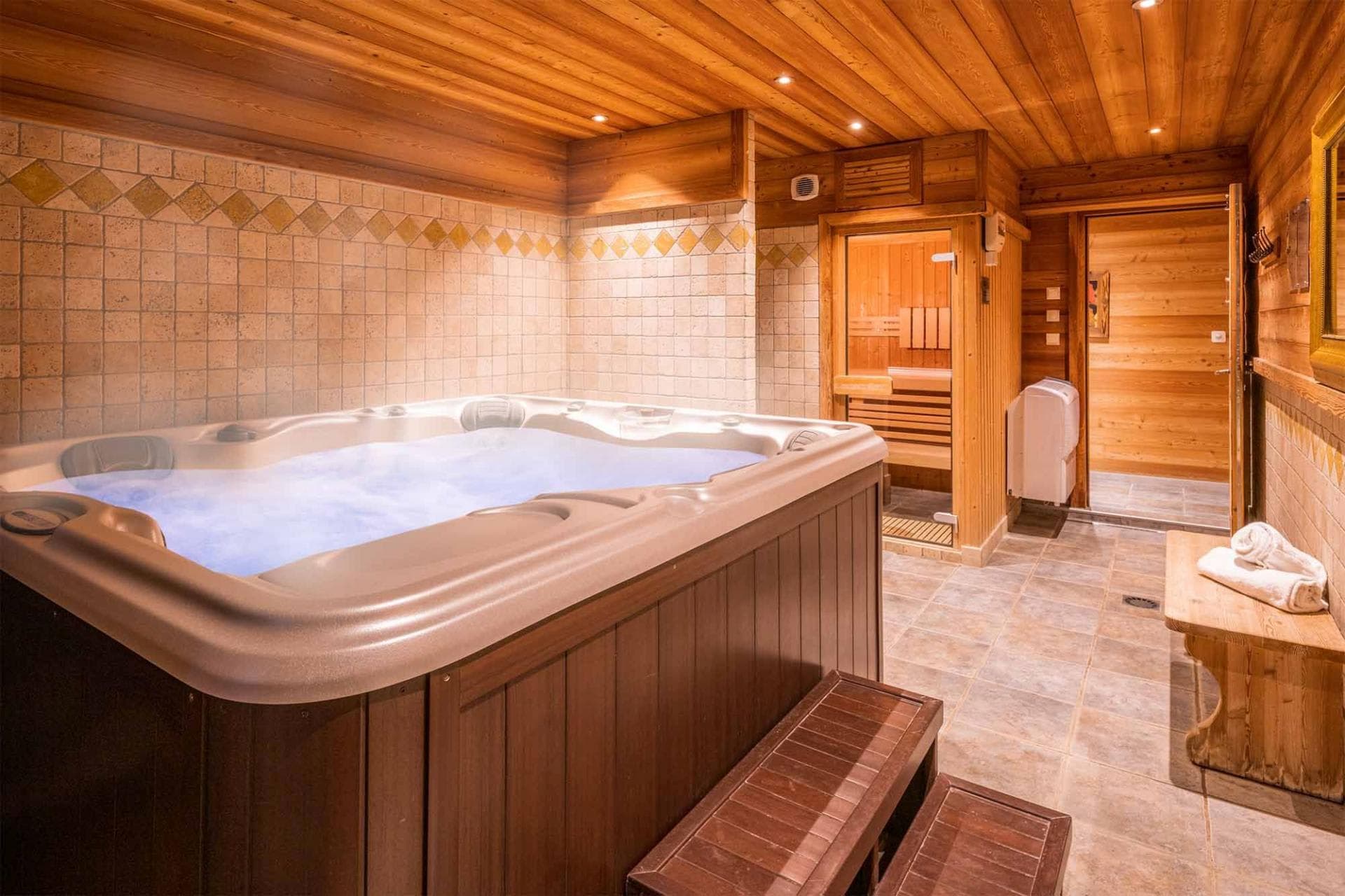 Indoor spa room with hot tub and private cedar sauna