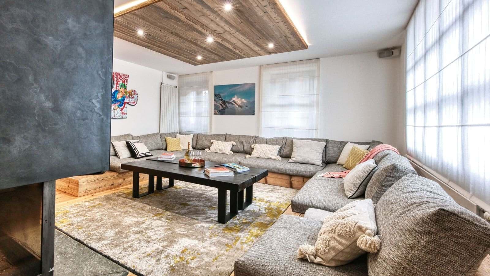 Living area with wood-burning fireplace and sectional seating for 10