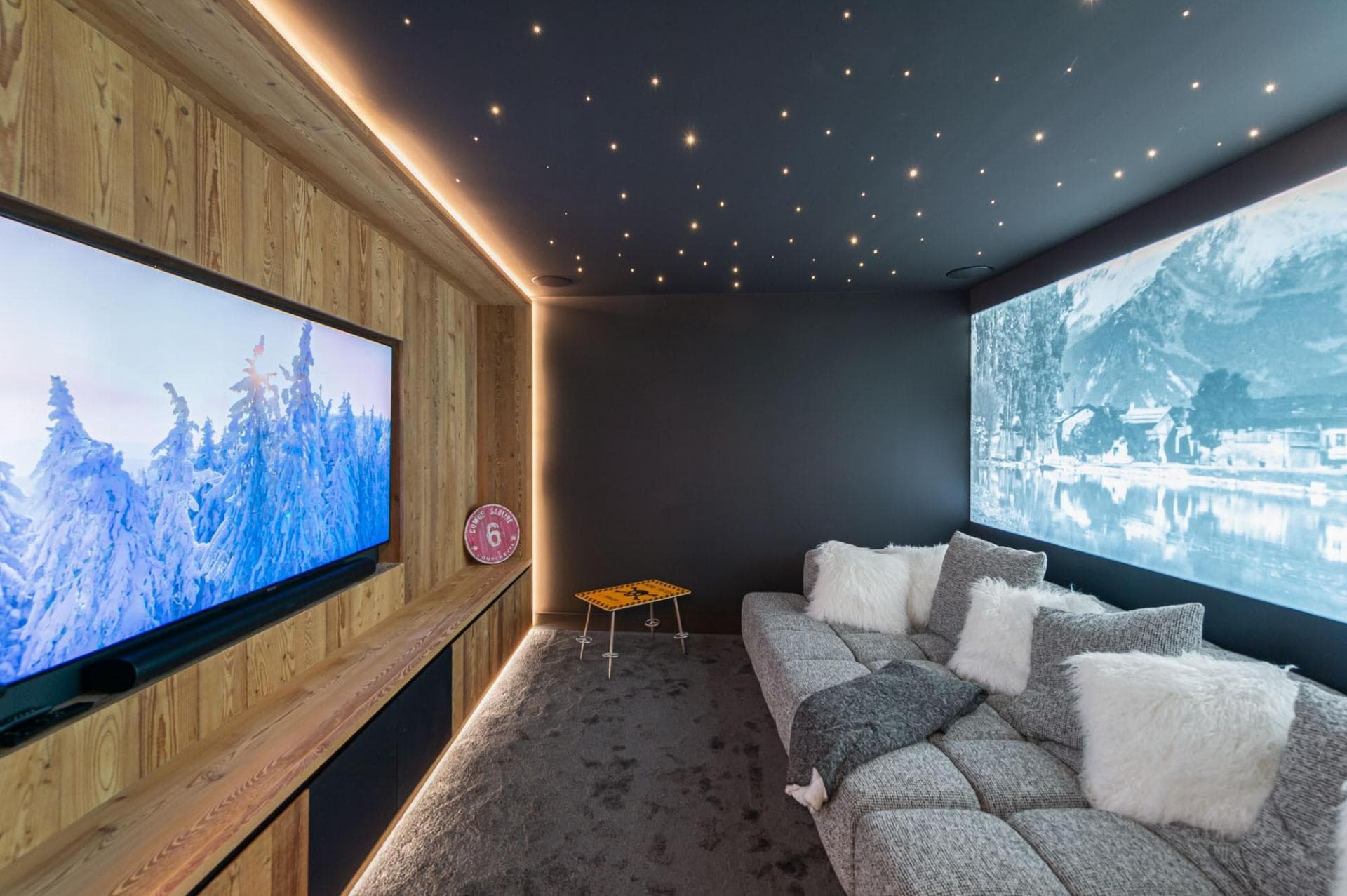 Media room featuring fiber-optic starlight ceiling and soundbar-equipped smart TV