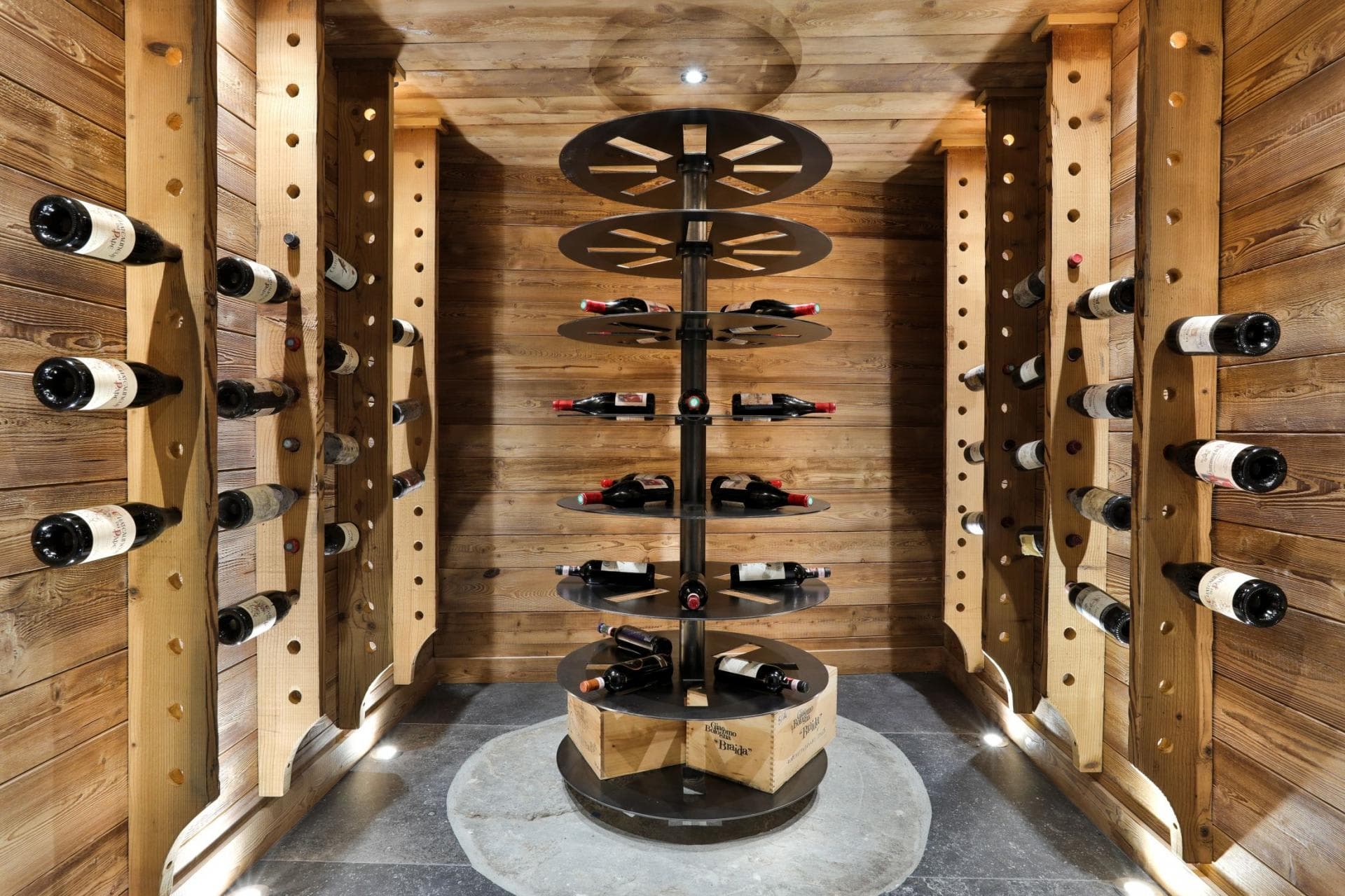 Temperature-controlled wine cellar with custom rotating carousel and wooden racks