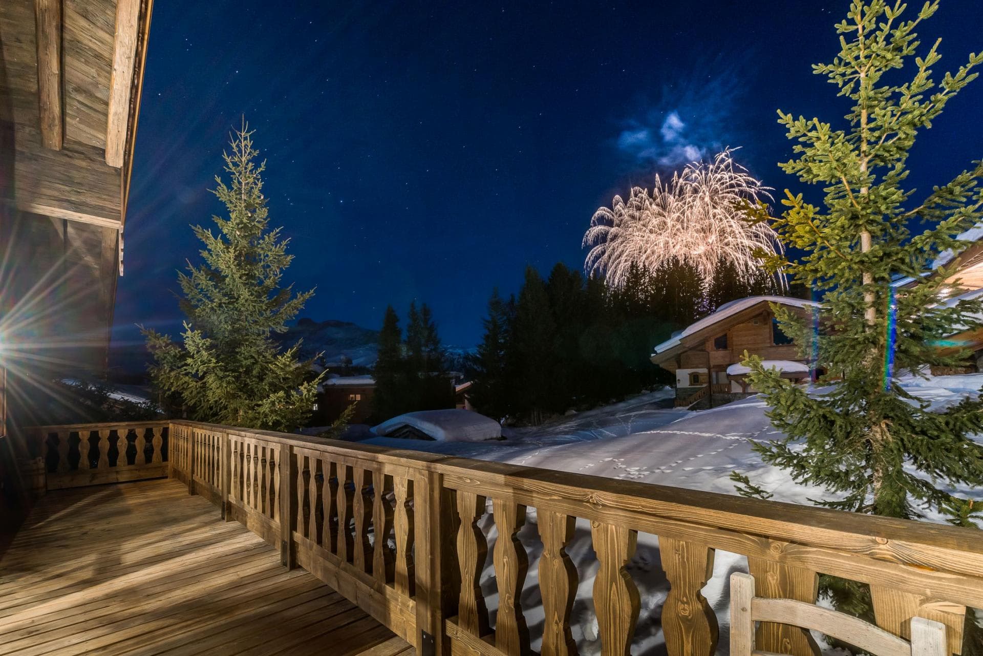 Private wooden balcony with views of village fireworks and night sky