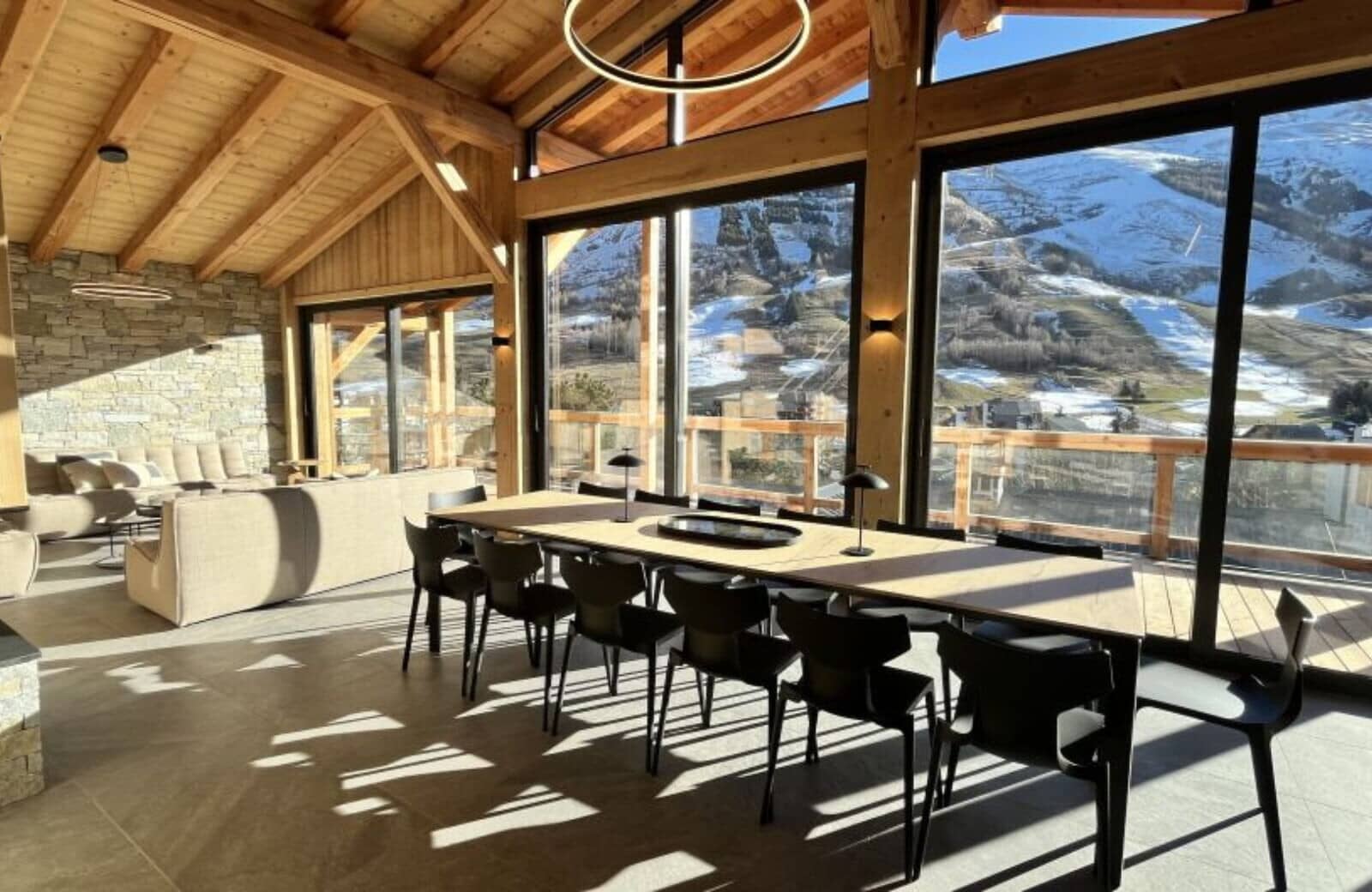 Dining table seats 12 with floor-to-ceiling ski slope views