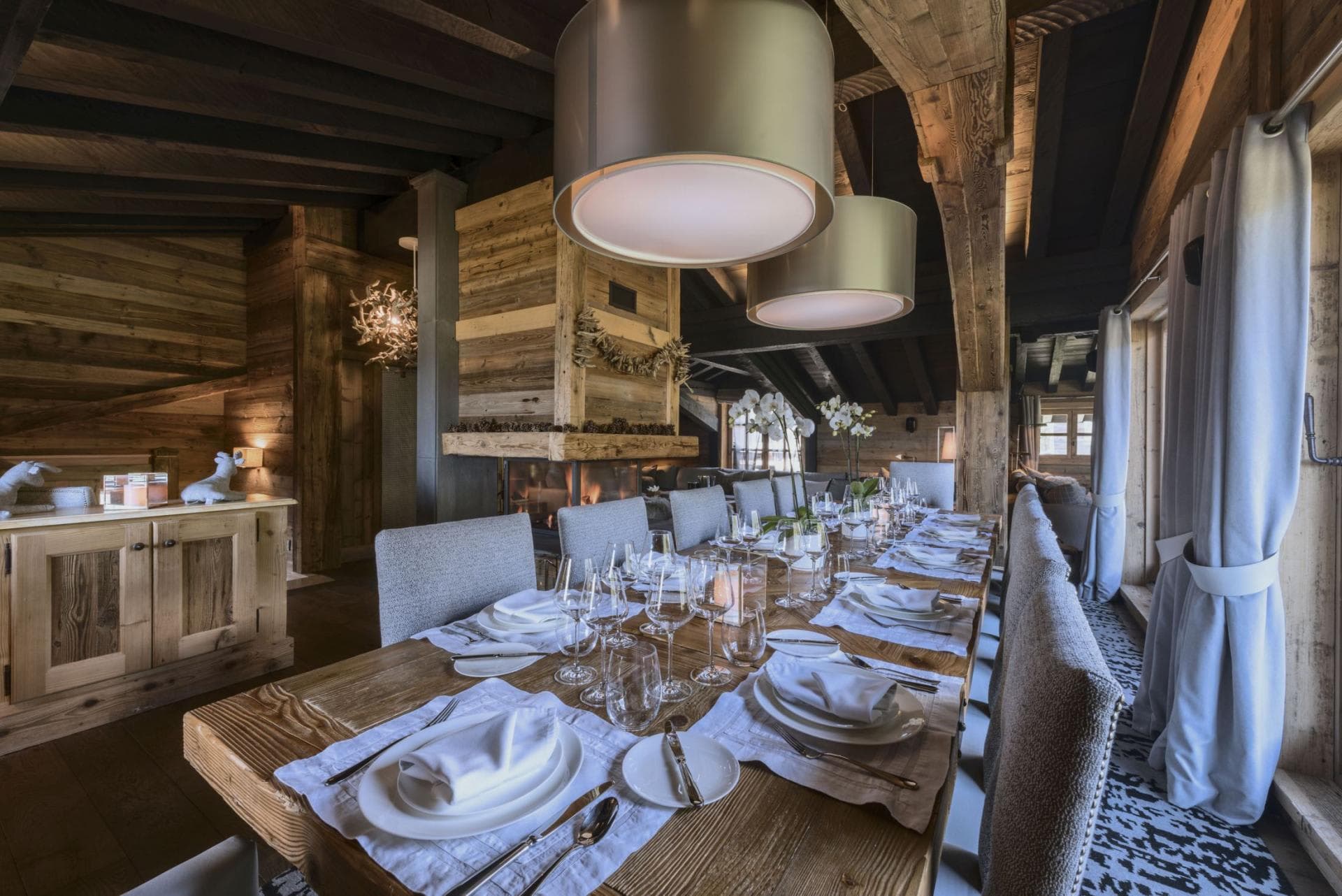 Dining area seats 12; features wood-burning fireplace and mountain-view windows