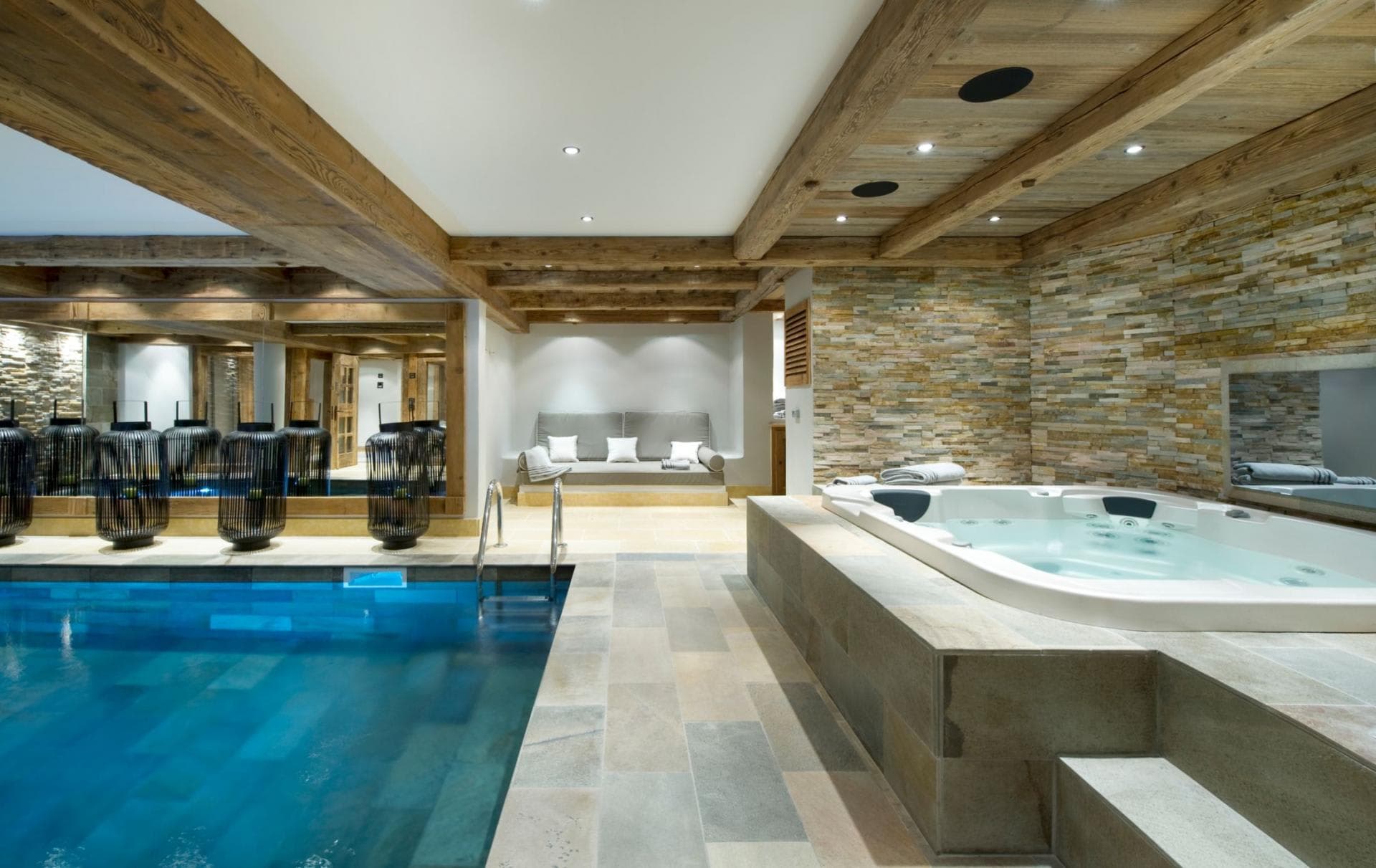 Indoor pool and hot tub with integrated ceiling speakers and daybed