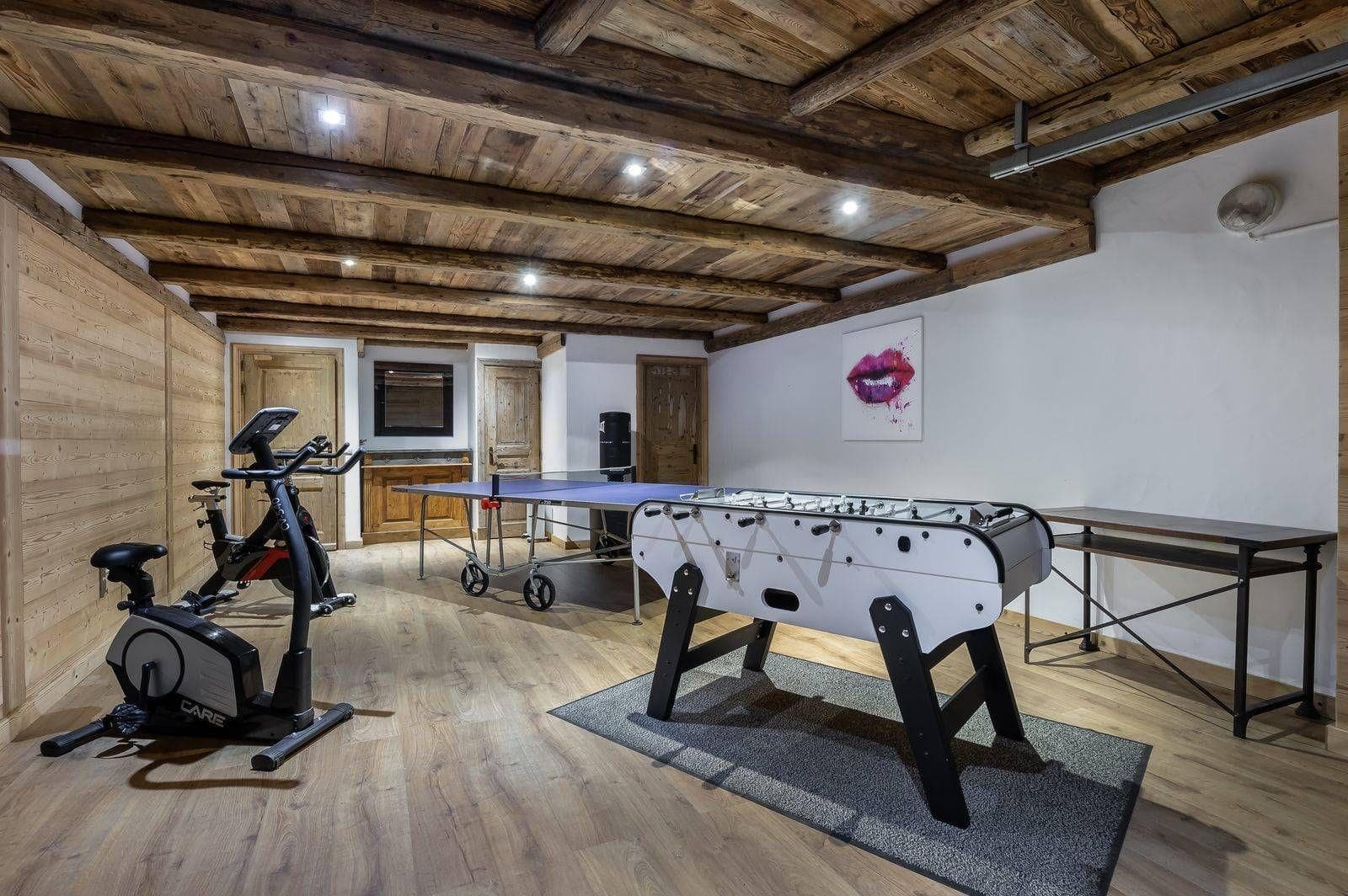 Game room with ping pong, foosball, and stationary exercise bikes