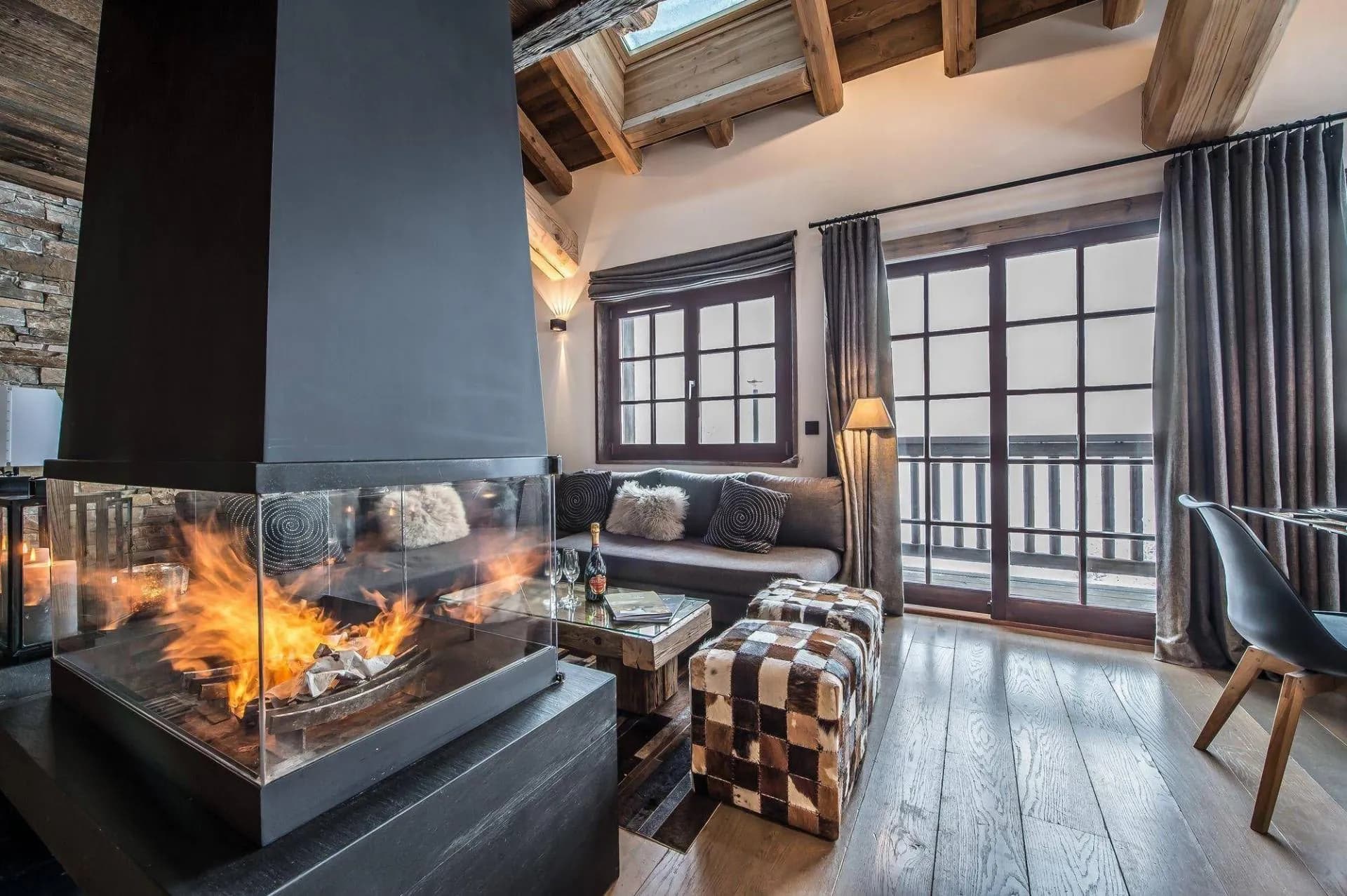 Living room beside the central fireplace and balcony doors