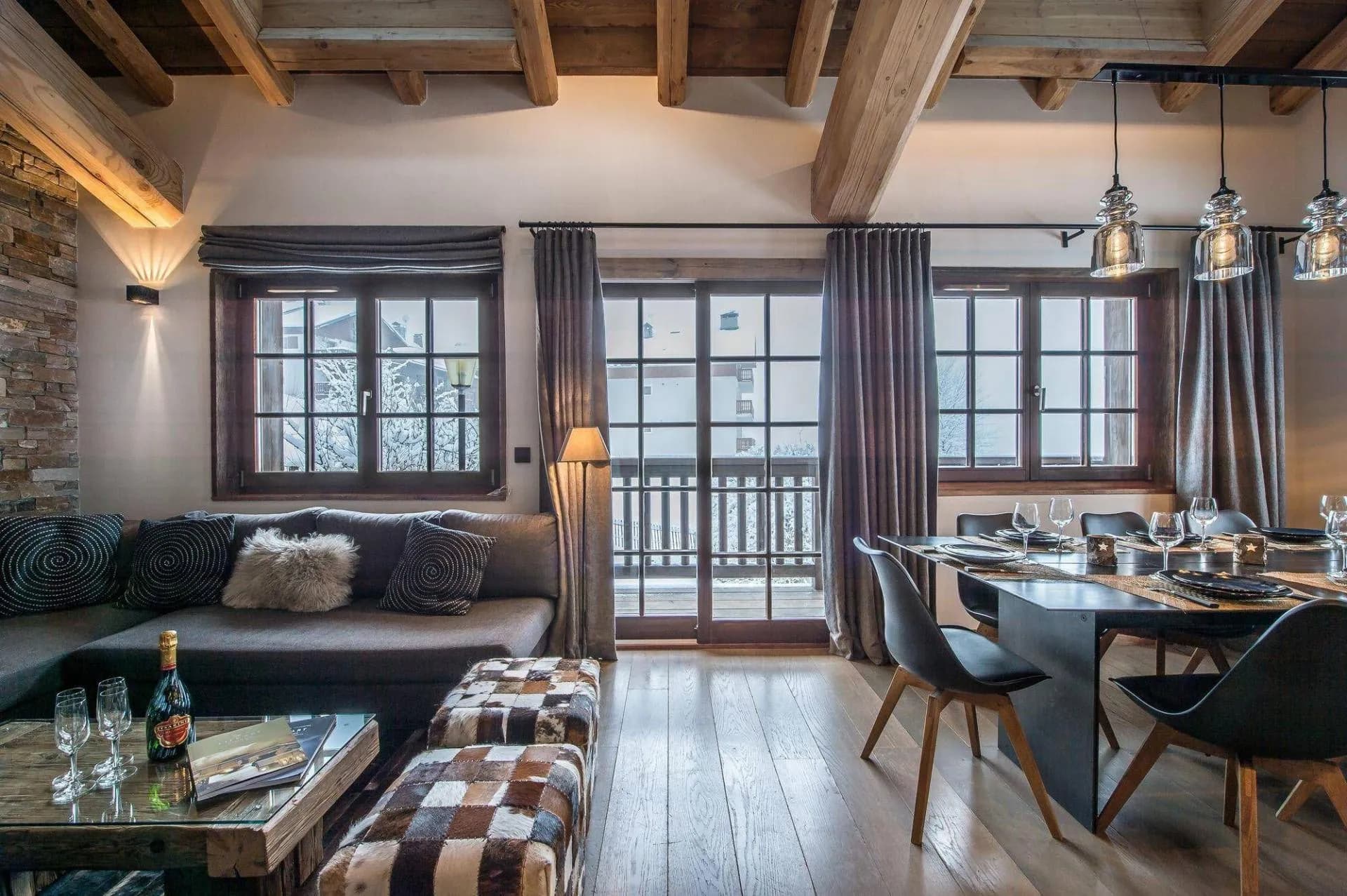 Living and dining area with large windows and balcony doors