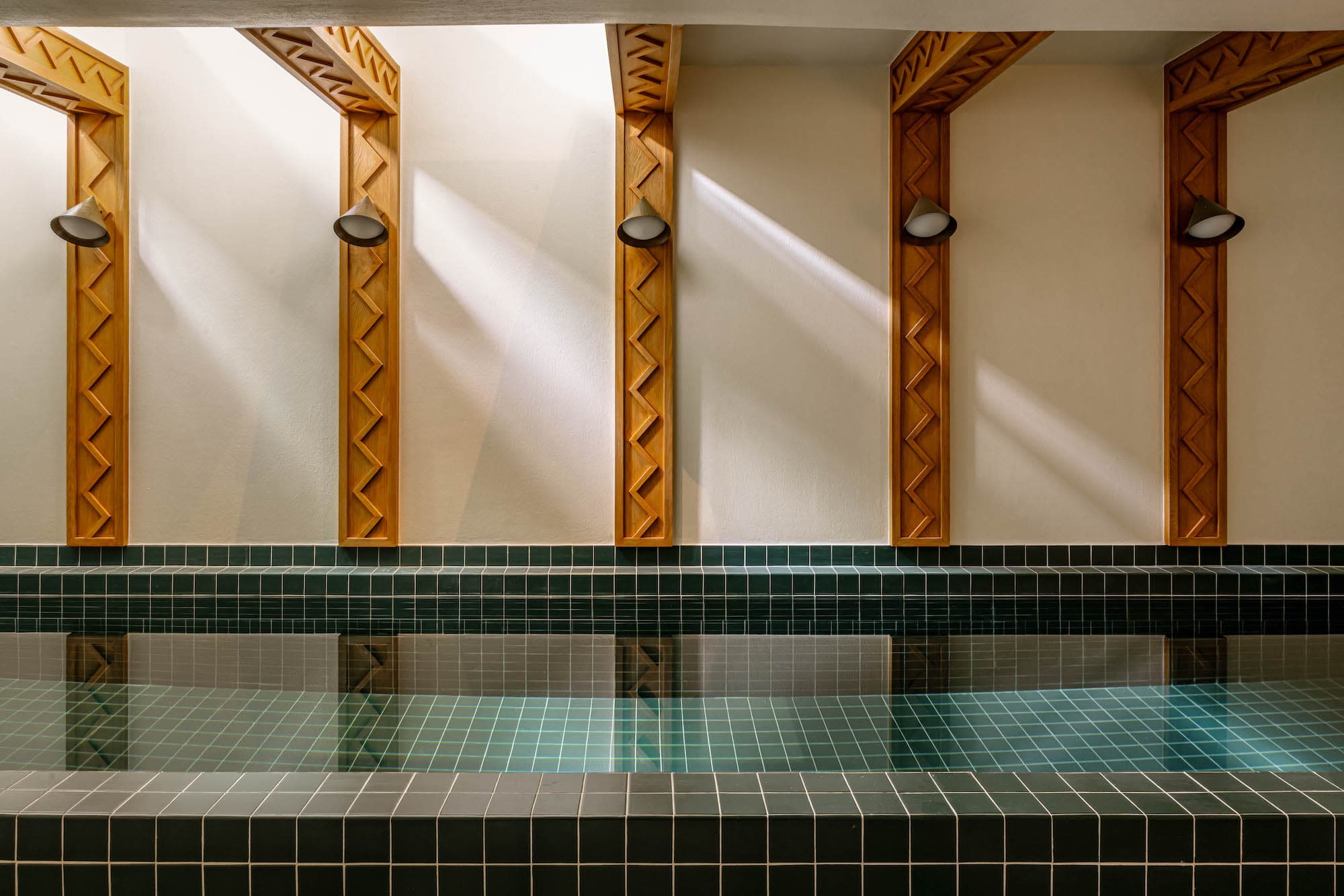 Indoor pool with skylights and custom carved wood architectural details