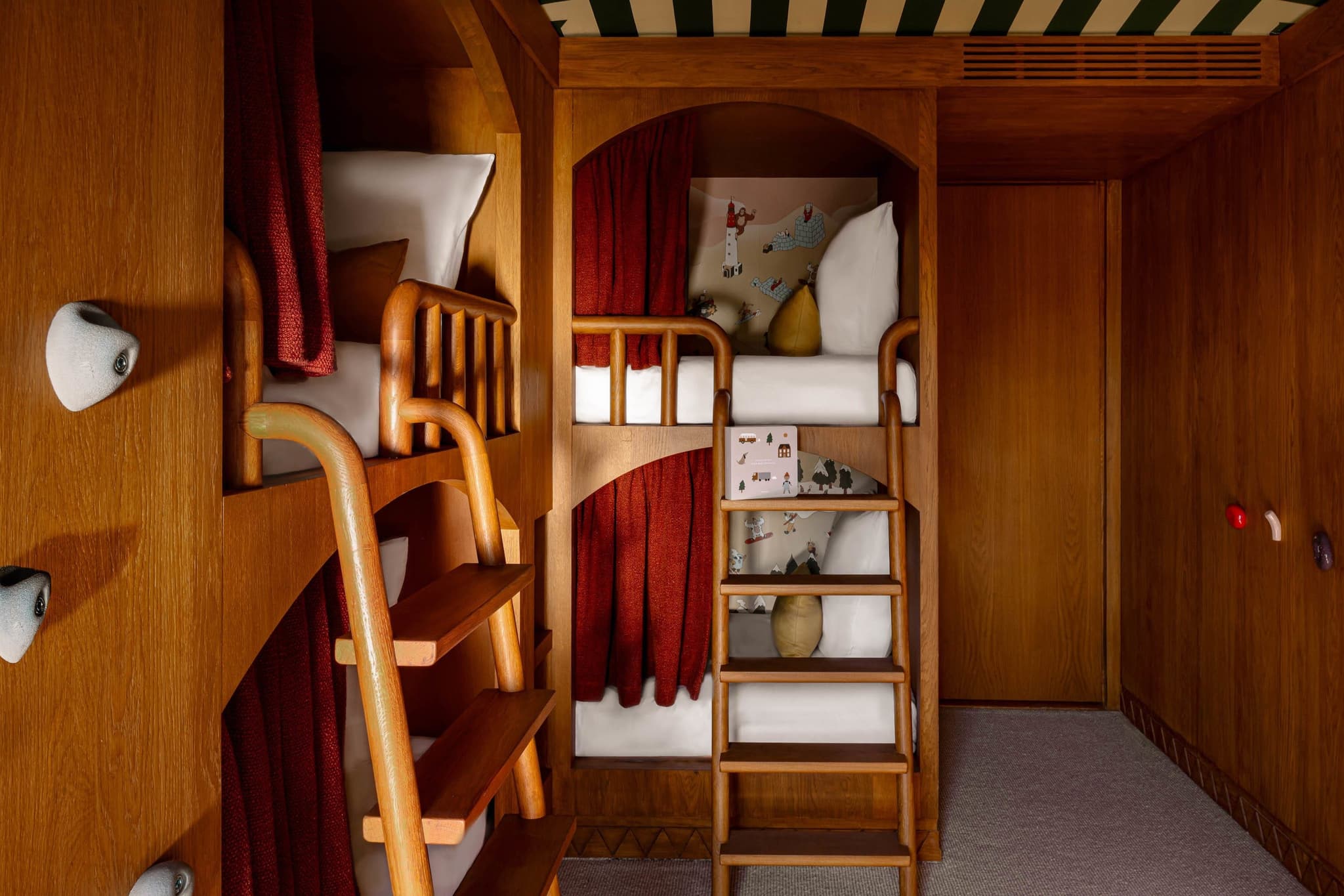 Bunk room with four built-in twin beds and rock-climbing wall