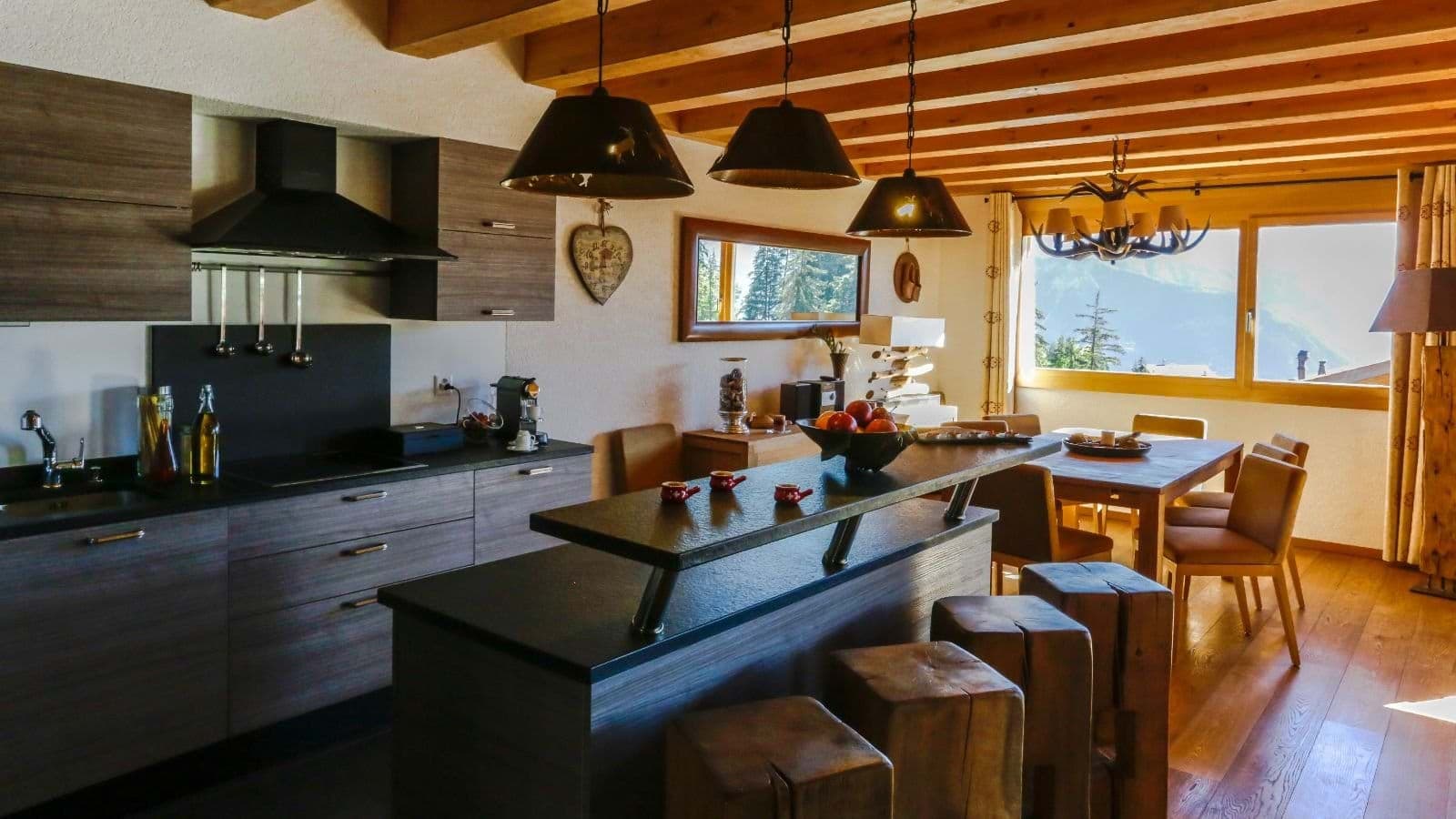 Kitchen with breakfast bar seating 4 and dining area with mountain views