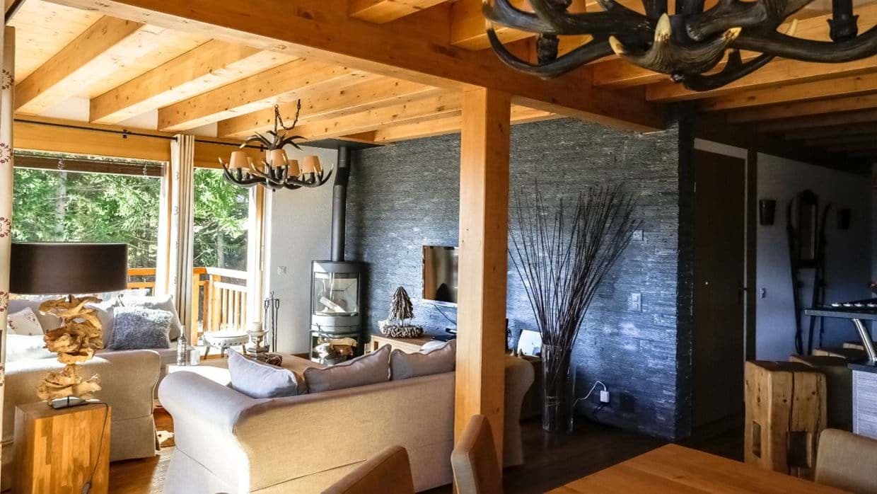 Living area with wood-burning stove and exposed timber beams