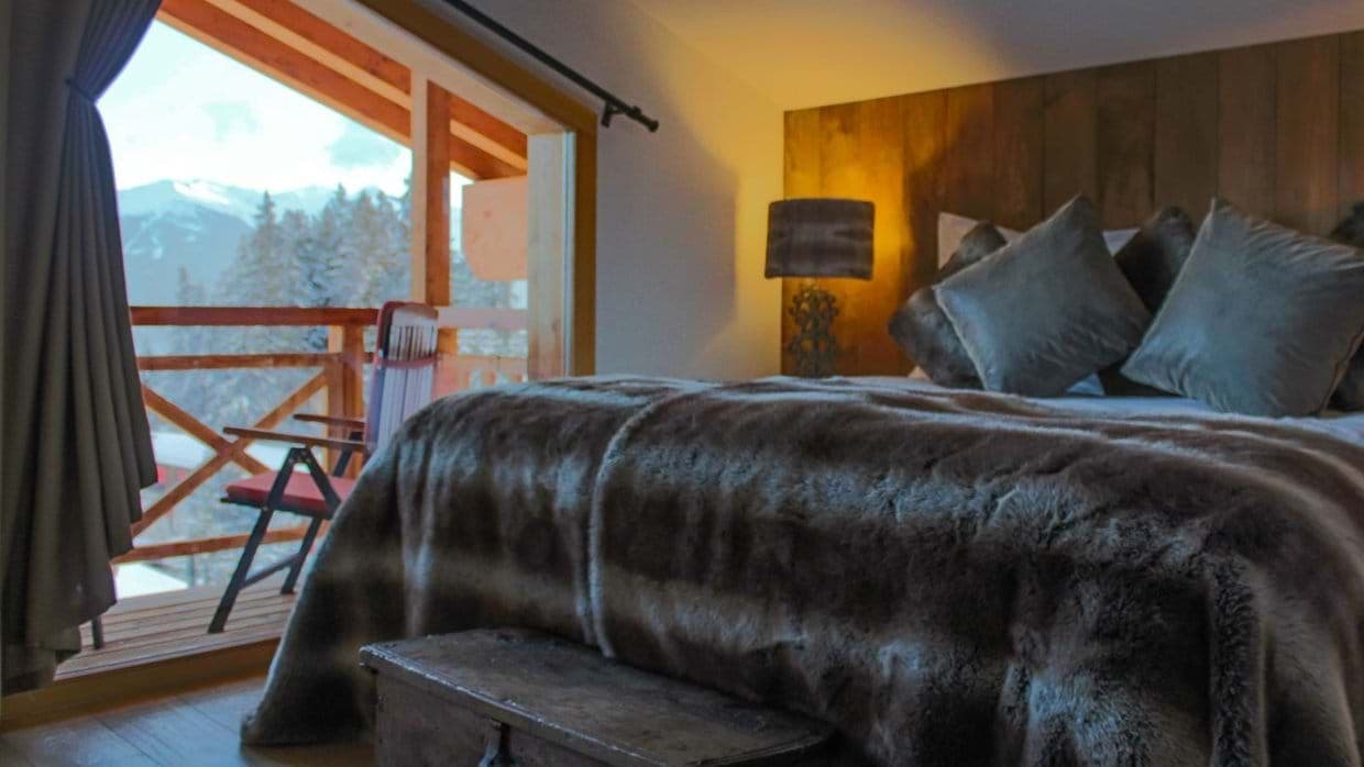 Bedroom with king bed, mountain views, and private balcony access