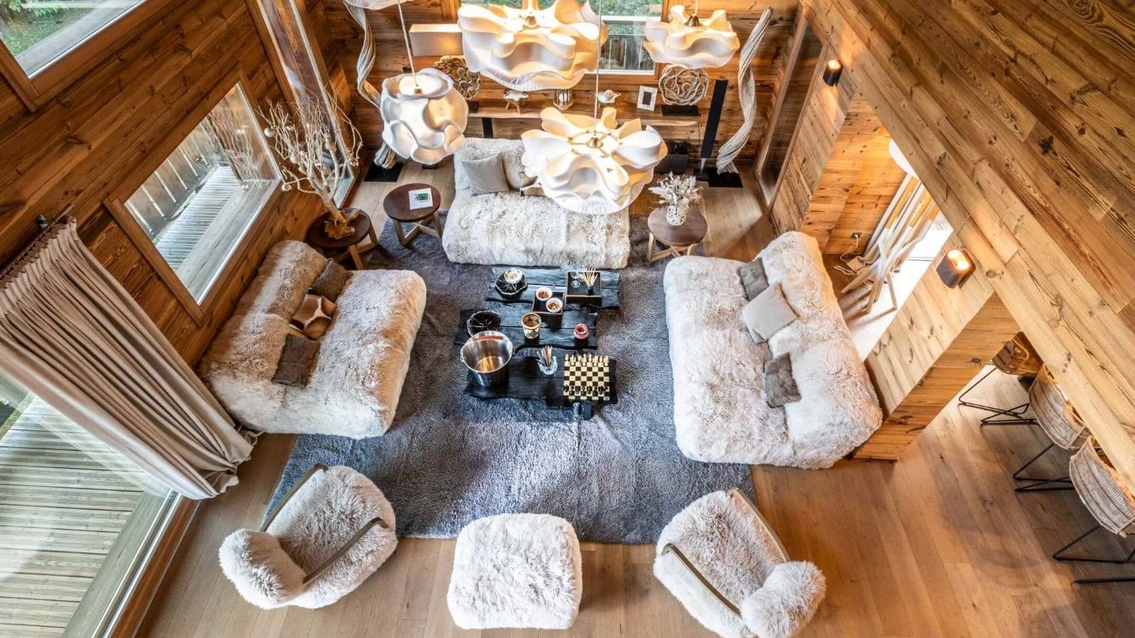 Main living area with faux-fur seating for 10 and wooden interior