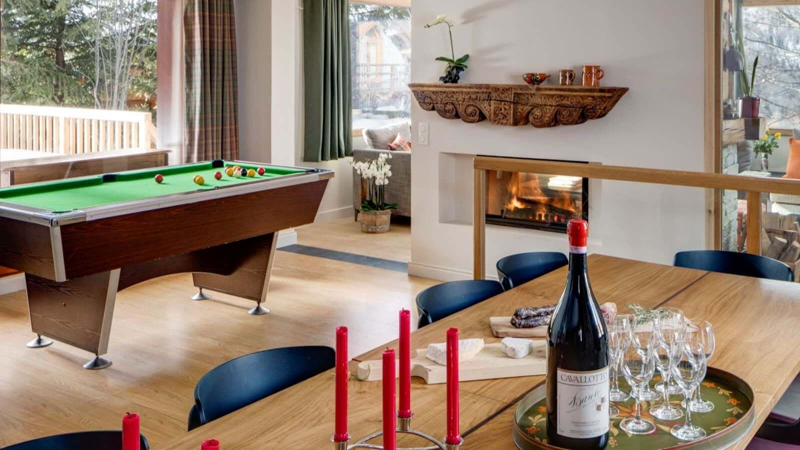 Open-plan dining area with pool table and wood-burning fireplace