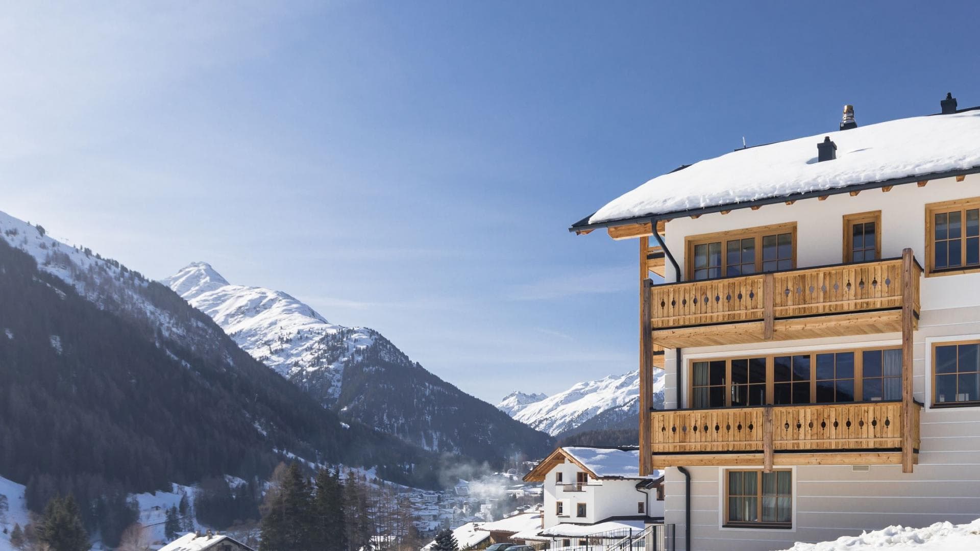 Chalet exterior featuring private timber balconies with alpine valley views