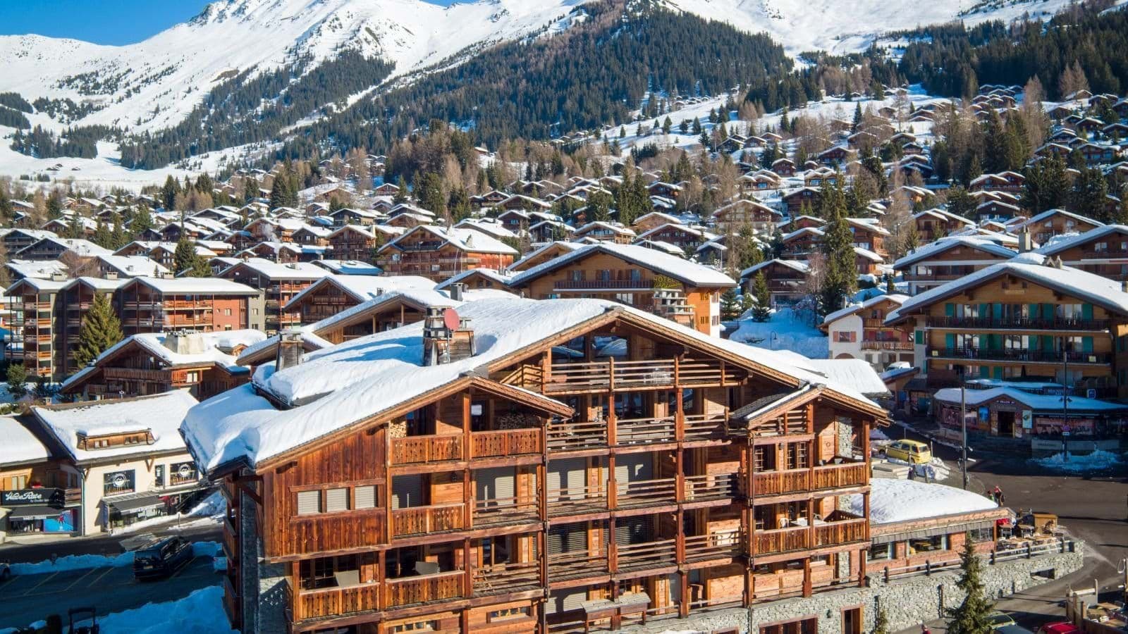 Chalet exterior with multiple private balconies and direct village access