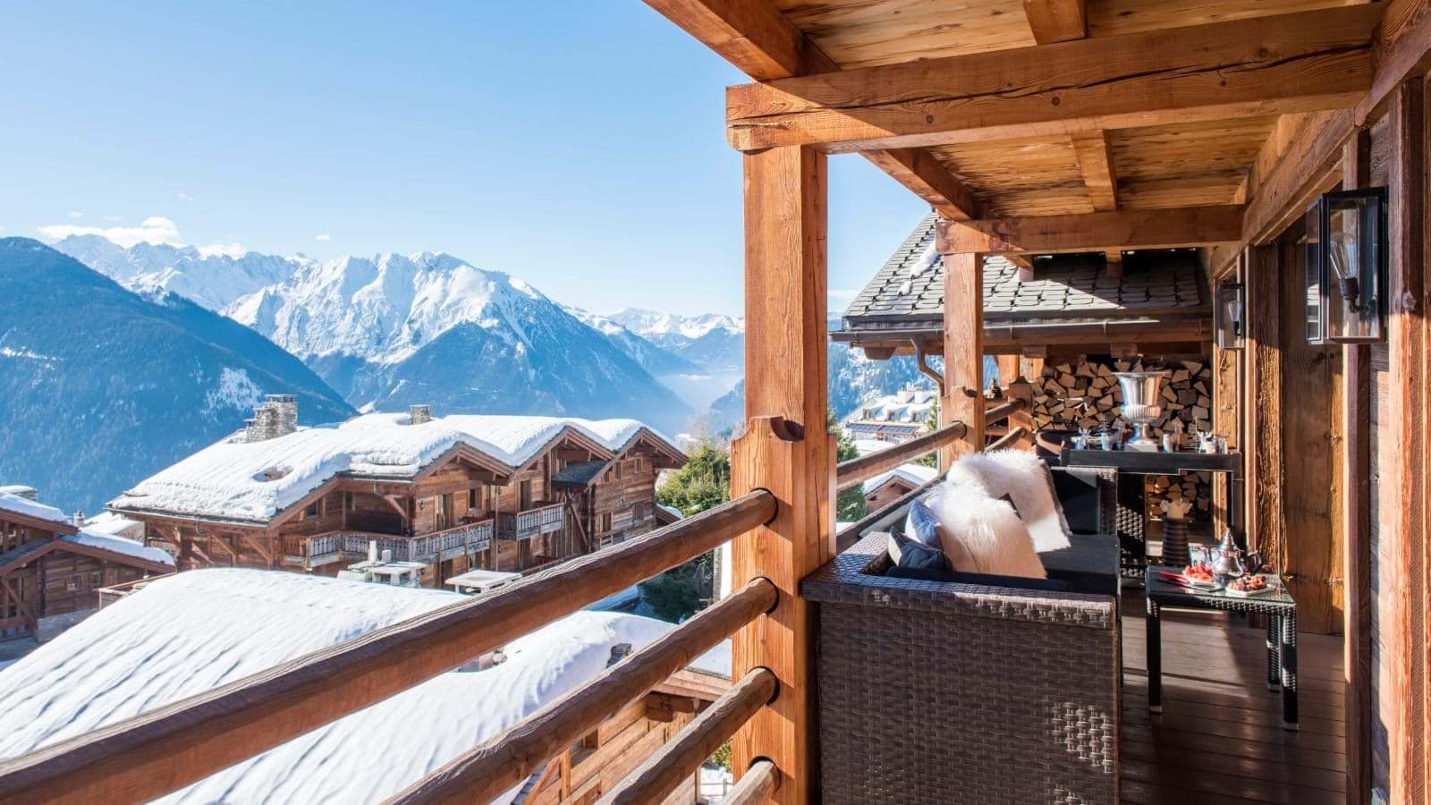 Covered balcony with lounge seating and panoramic mountain views