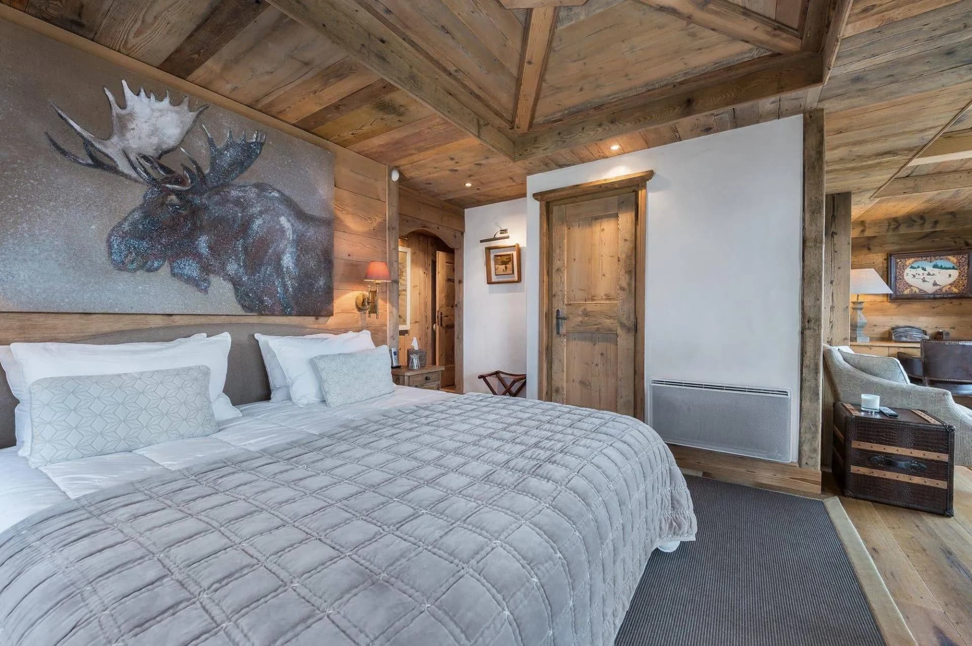 Double bedroom with timber walls and mountain artwork