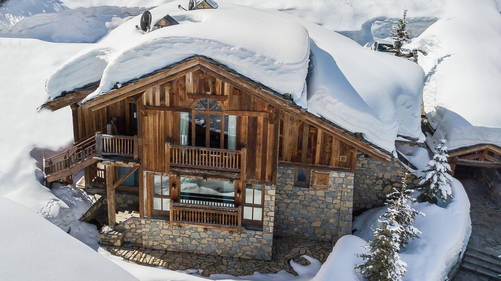 Timber and stone chalet with private balconies and direct snow access