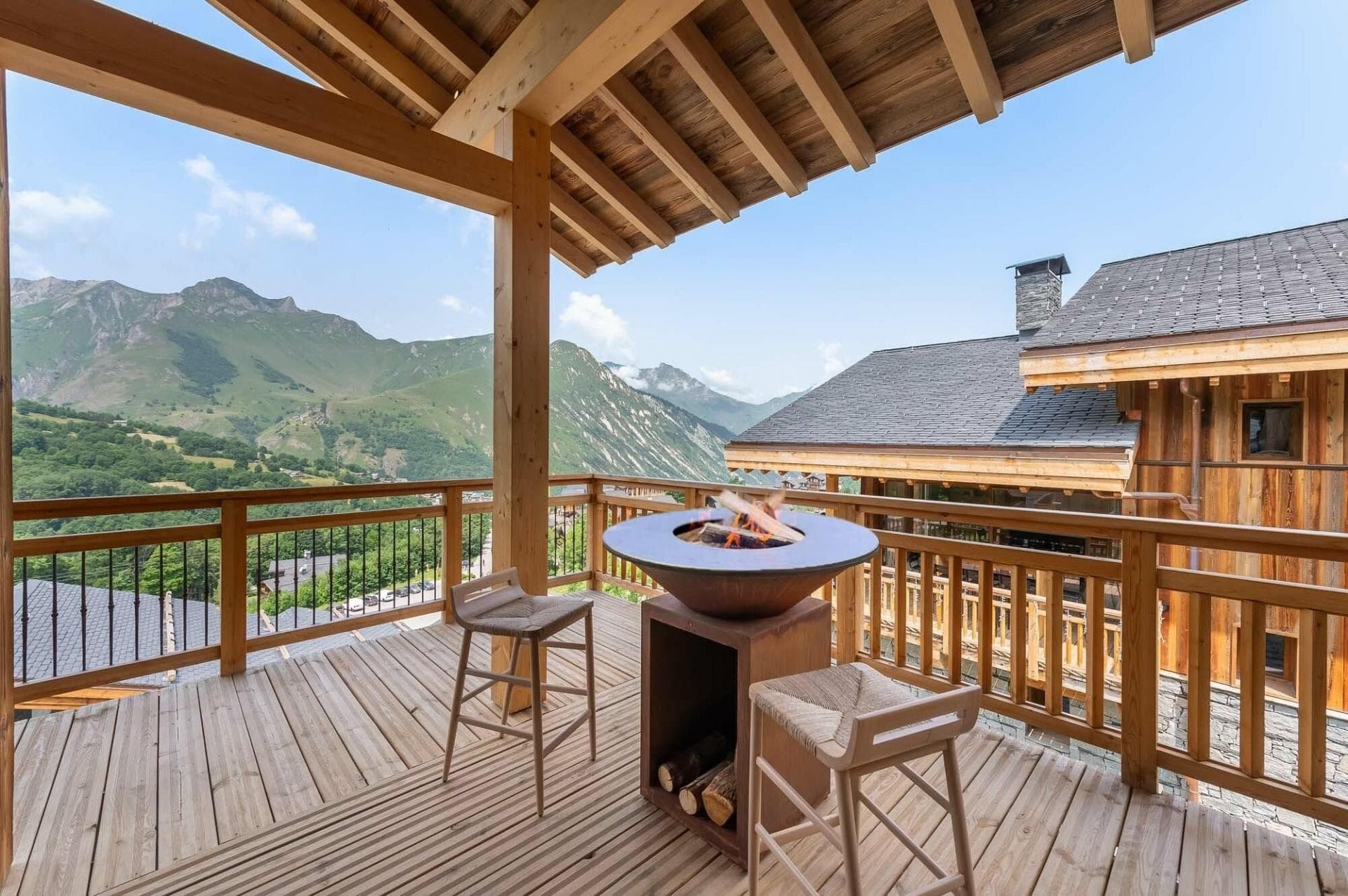 Covered balcony with wood-burning fire pit and mountain views