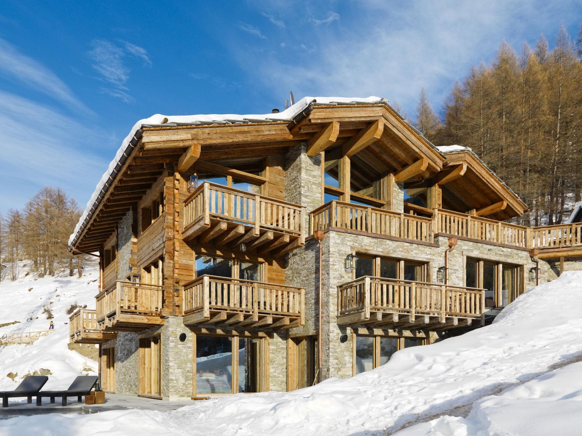 Ski-in/ski-out chalet with private balconies and stone-wood exterior
