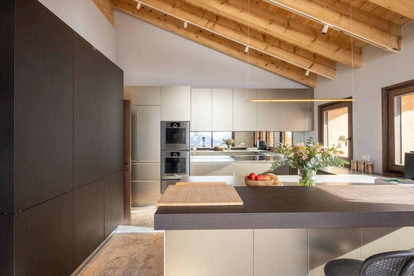 Kitchen with double wall ovens and vaulted wood ceiling